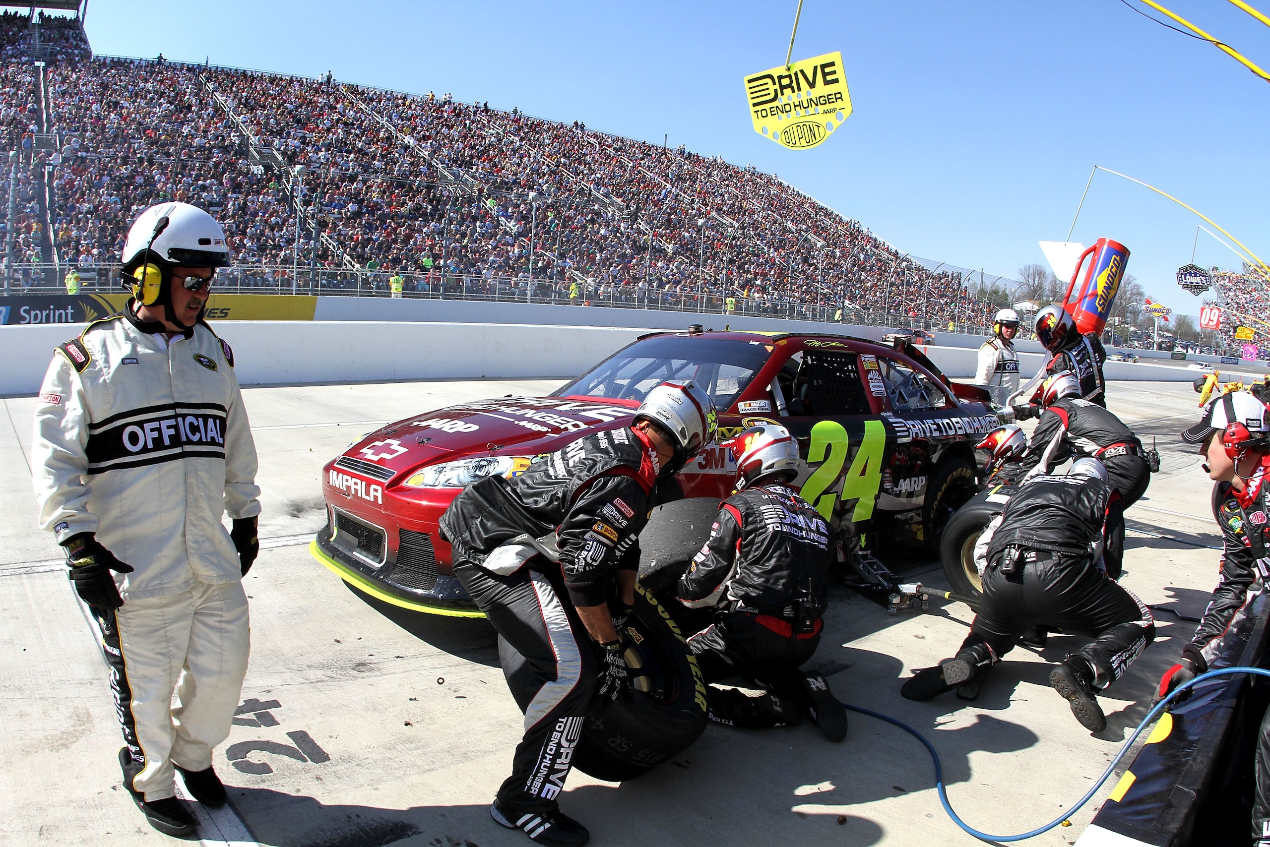 MARTINSVILLE, VA - APRIL 03:  Jeff Gordon, driver of the #24 Drive to End Hunger/ AARP Chevrolet, makes a pit stop during the NASCAR Sprint Cup Series Goody's Fast Relief 500 at Martinsville Speedway on April 3, 2011 in Martinsville, Virginia.  (Photo by
