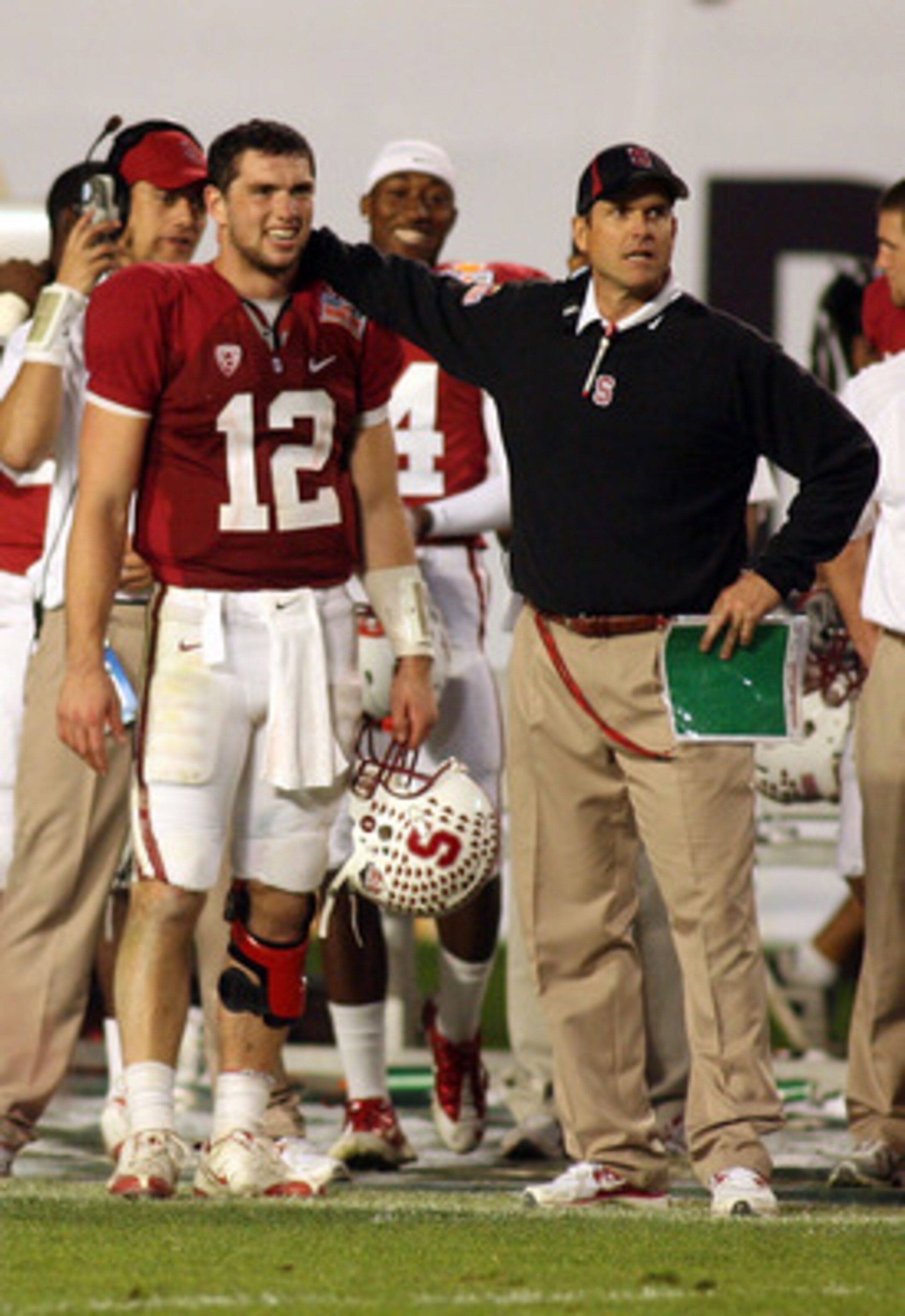MIAMI, FL - JANUARY 03:  (L-R) Quarterback Andrew Luck #12 and head coach Jim Harbaugh of the Stanford Cardinal look on from the sideline late in the fourth quarter against the Virginia Tech Hokies during the 2011 Discover Orange Bowl at Sun Life Stadium