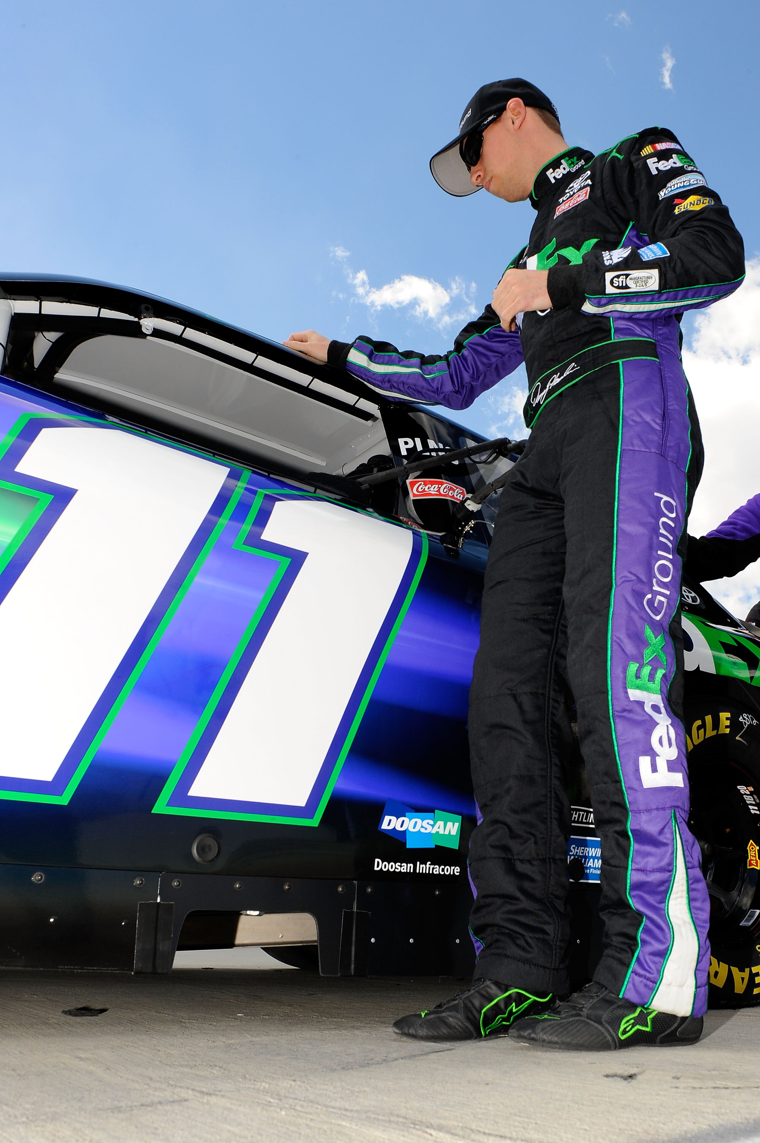 MARTINSVILLE, VA - APRIL 02:  Denny Hamlin, driver of the #11 FedEx Ground Toyota, stands next to his car on the grid during qualifying for the NASCAR Sprint Cup Series Goody's Fast Relief 500 at Martinsville Speedway on April 2, 2011 in Martinsville, Vir