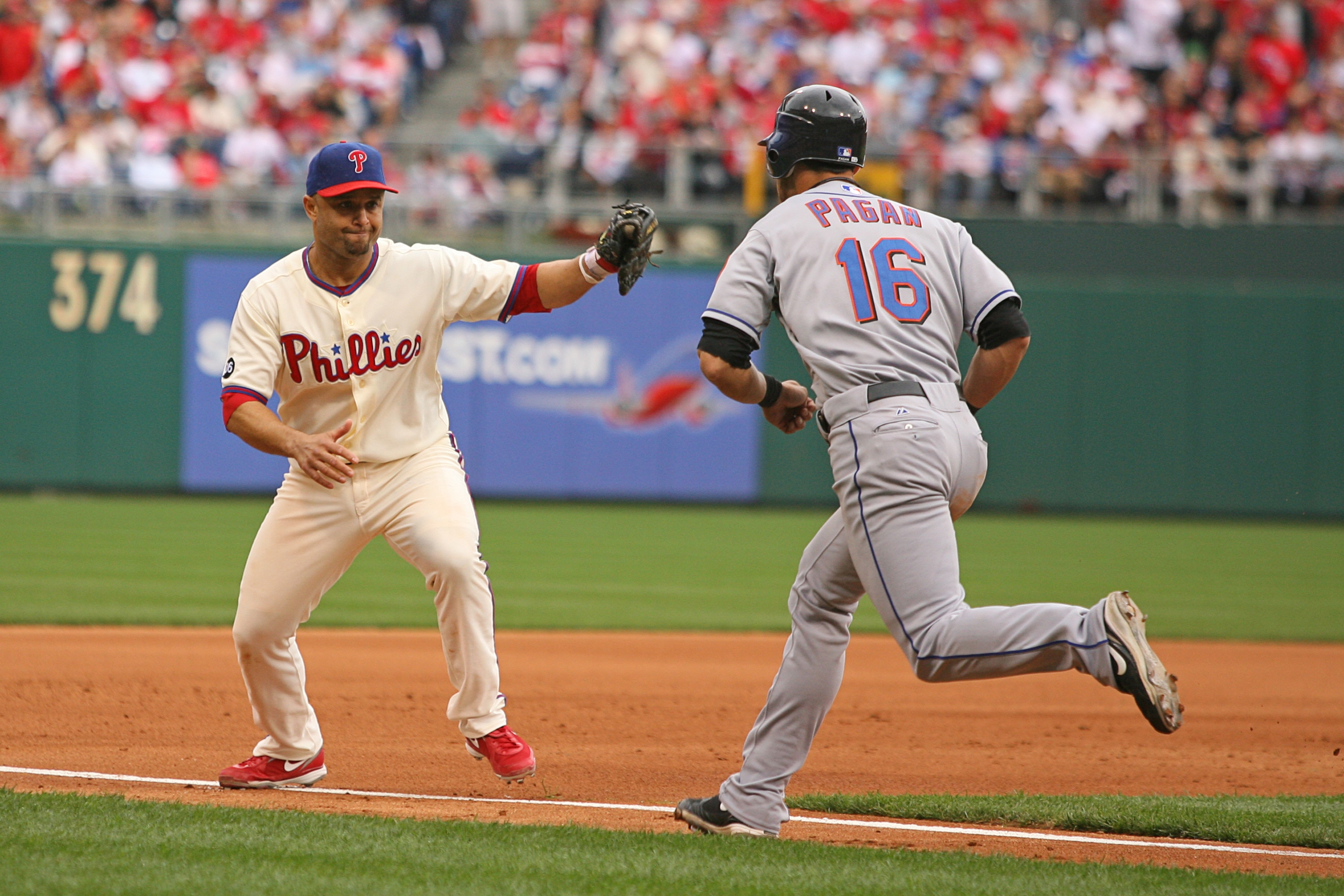 PHILADELPHIA - SEPTEMBER 26: Third baseman Placido Polanco #27 of the Philadelphia Phillies tags out center fielder Angel Pagan #16 of the New York Mets during a game at Citizens Bank Park on September 26, 2010 in Philadelphia, Pennsylvania. (Photo by Hun