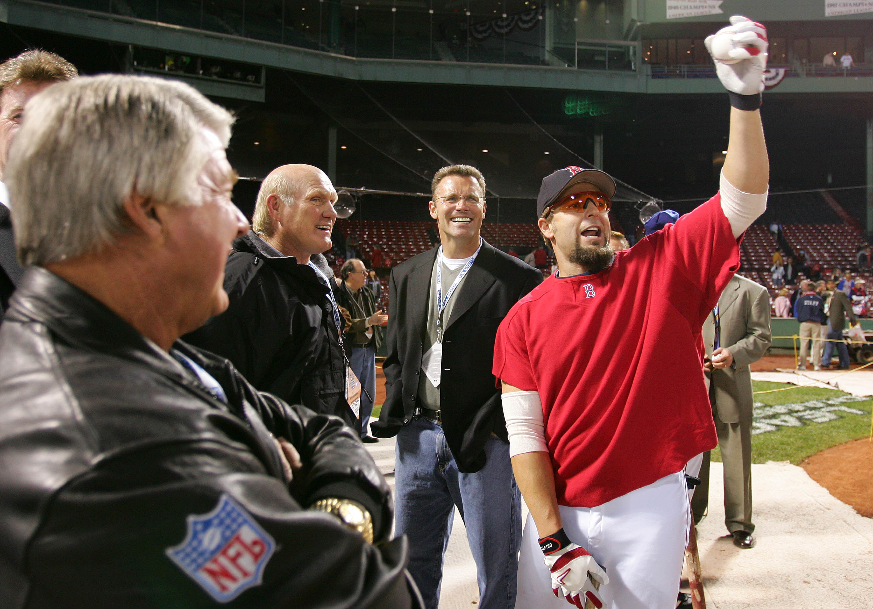 BOSTON - OCTOBER 16:  Kevin Millar #15 of the Boston Red Sox shares a laugh with Fox NFL television sportscasters, from left, Jimmy Johnson, Terry Bradshaw, and Howie Long before game three of the American League Championship Series against the New York Y