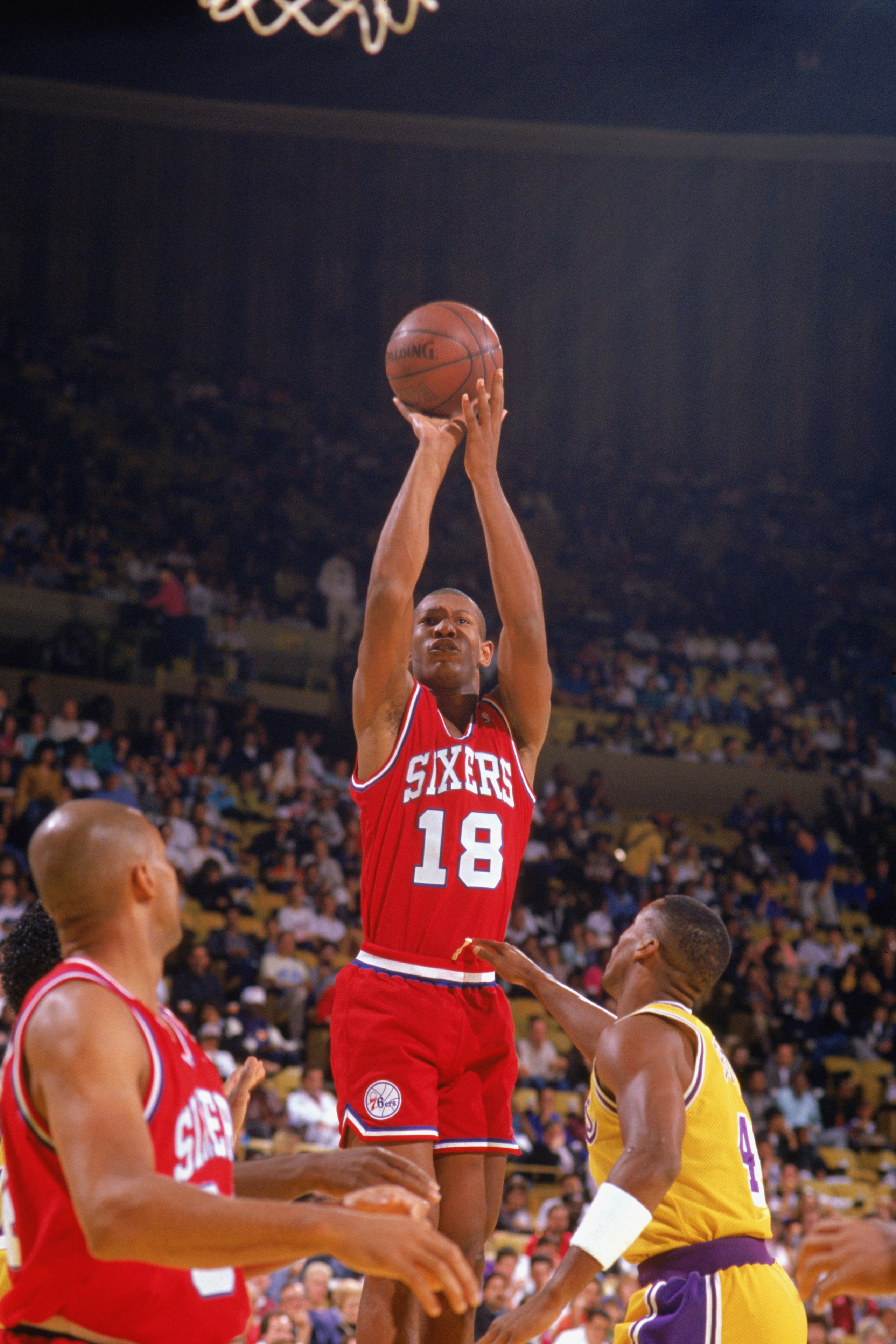LOS ANGELES - 1989:  Kenny Payne #18 of the Philadelphia 76ers shoots against the Los Angele Lakers during the 1989-1990 NBA season game at the Great Western Forum in Los Angeles, California. (Photo by Ken Levine/Getty Images)