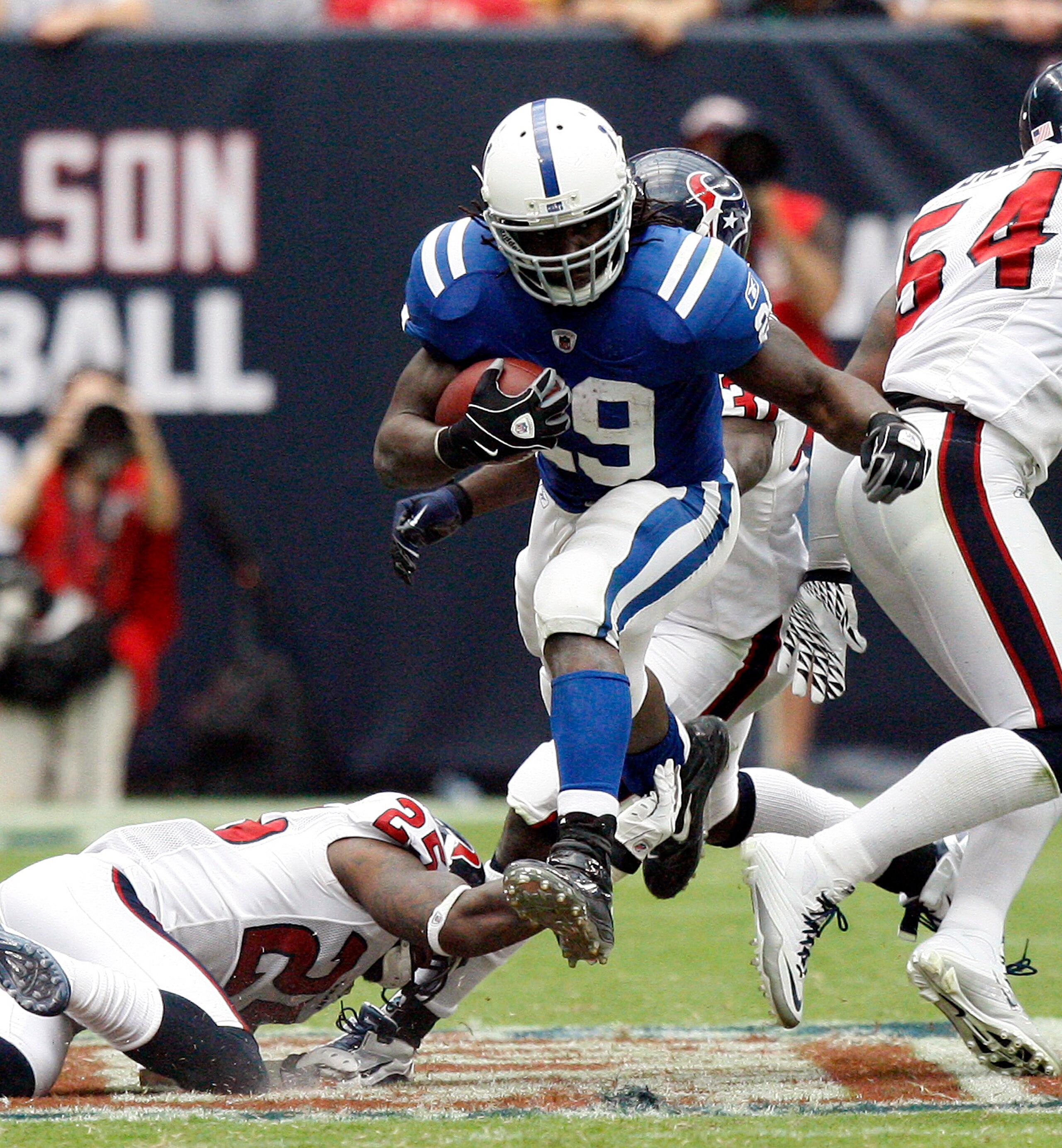 HOUSTON - SEPTEMBER 12:  Running back Joseph Addai #29 of the Indianapolis Colts rushes up the middle over cornerback Kareem Jackson #25 of the Houston Texans during the NFL season opener at Reliant Stadium on September 12, 2010 in Houston, Texas. Houston