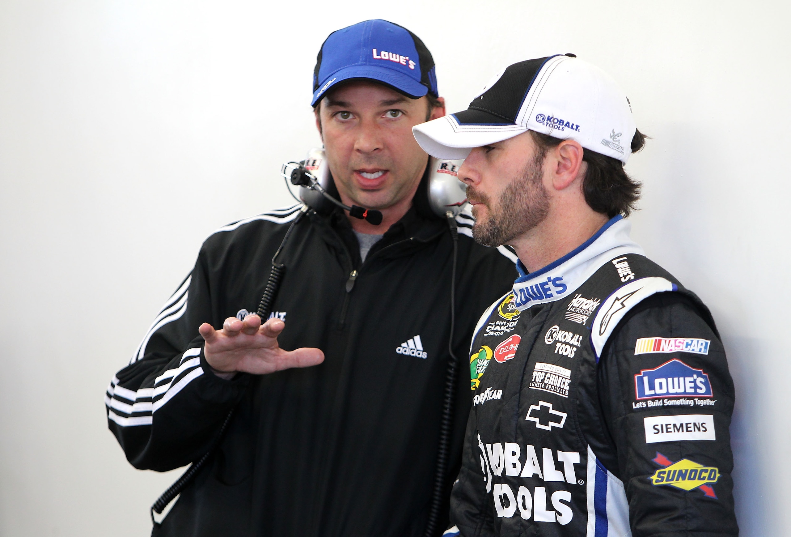 LAS VEGAS, NV - MARCH 04:  Crew chief Chad Knaus (L) talks with Jimmie Johnson, driver of the #48 Lowe's/Kobalt Tools Chevrolet, in the garage area during practice for the NASCAR Sprint Cup Series Kobalt Tools 400 at Las Vegas Motor Speedway on March 4, 2