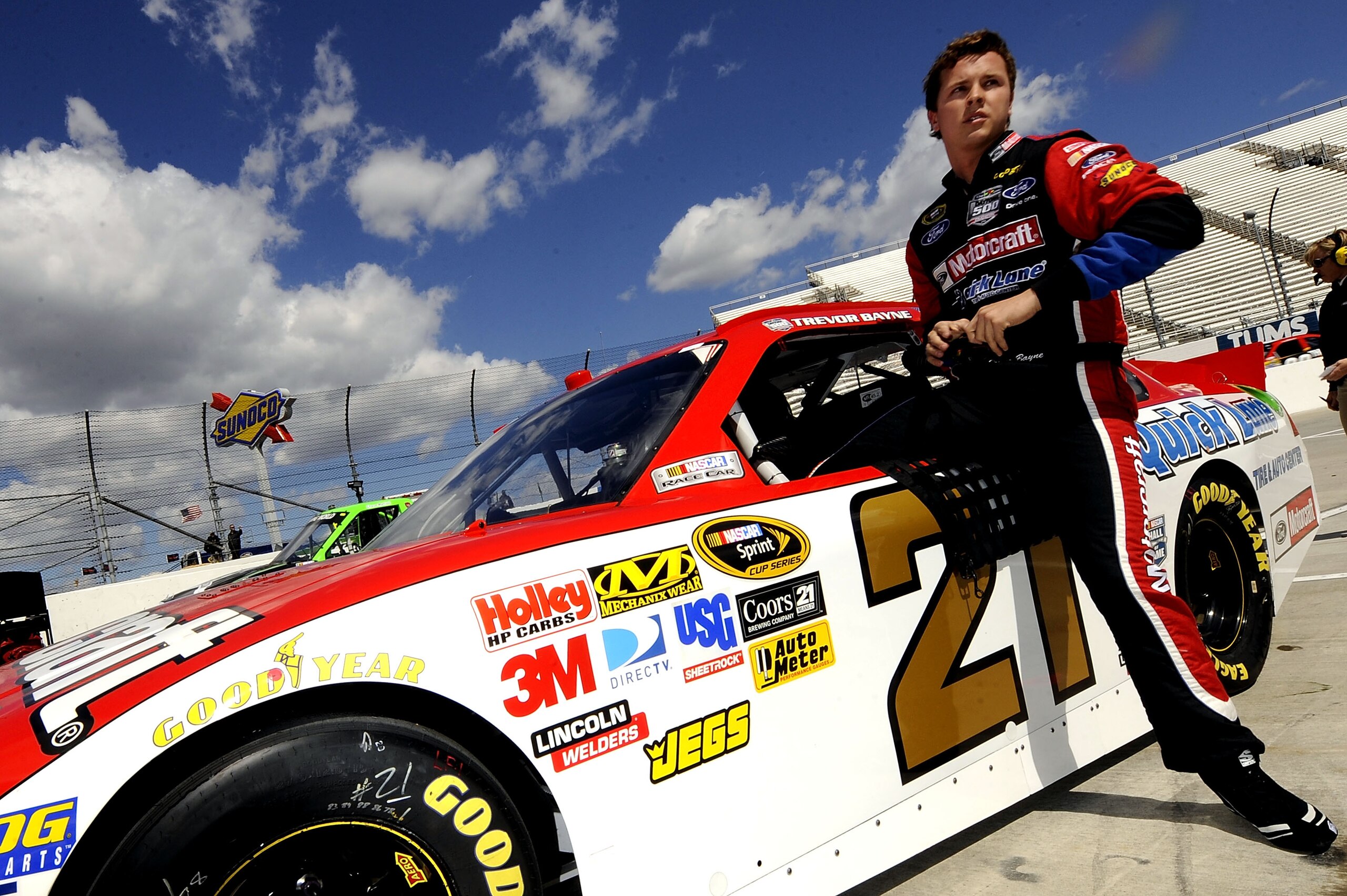 MARTINSVILLE, VA - APRIL 02:  Trevor Bayne, driver of the #21 Motorcraft/Quick Lane Tire & Auto Center Ford, climbs out of his car on the grid after qualifying for the NASCAR Sprint Cup Series Goody's Fast Relief 500 at Martinsville Speedway on April 2, 2