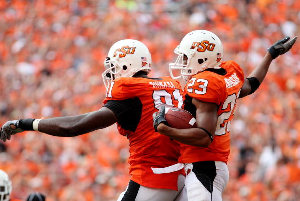 STILLWATER, OK - SEPTEMBER 5:  Ugo Chinasa #91 and Terrance Anderson #23 of the Oklahoma State Cowboys defense celebrate recovering a fumble  in the second quarter of the game against the Georgia Bulldogs at Boone Pickens Stadium on September 5, 2009 in S