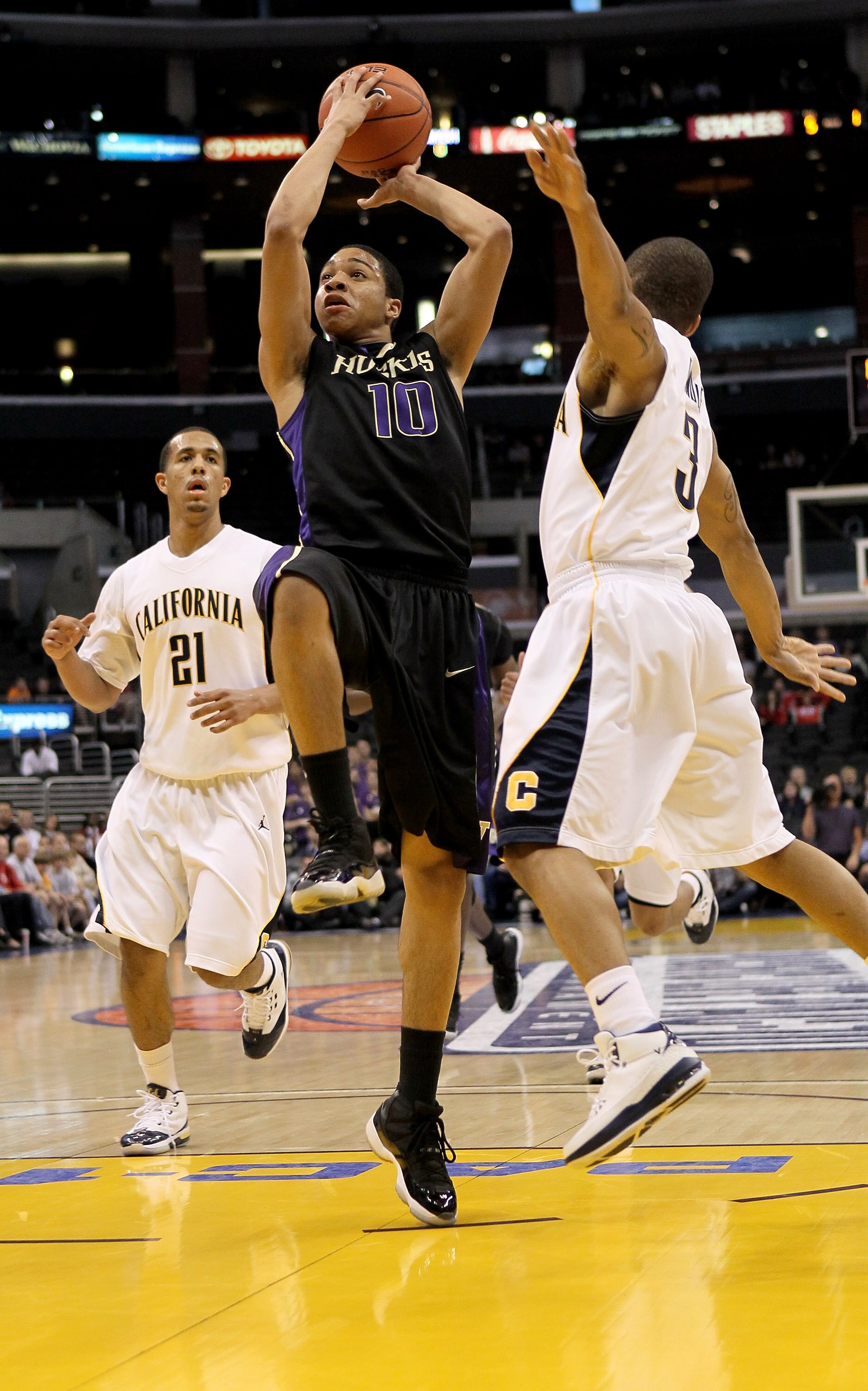 LOS ANGELES, CA - MARCH 13:  Abdul Gaddy #10 of the Washington Huskies goes up for a shot over Jerome Randle #3 and Omondi Amoke #21 of the California Golden Bears during the championship game of the Pac-10 Basketball Tournament at Staples Center on March