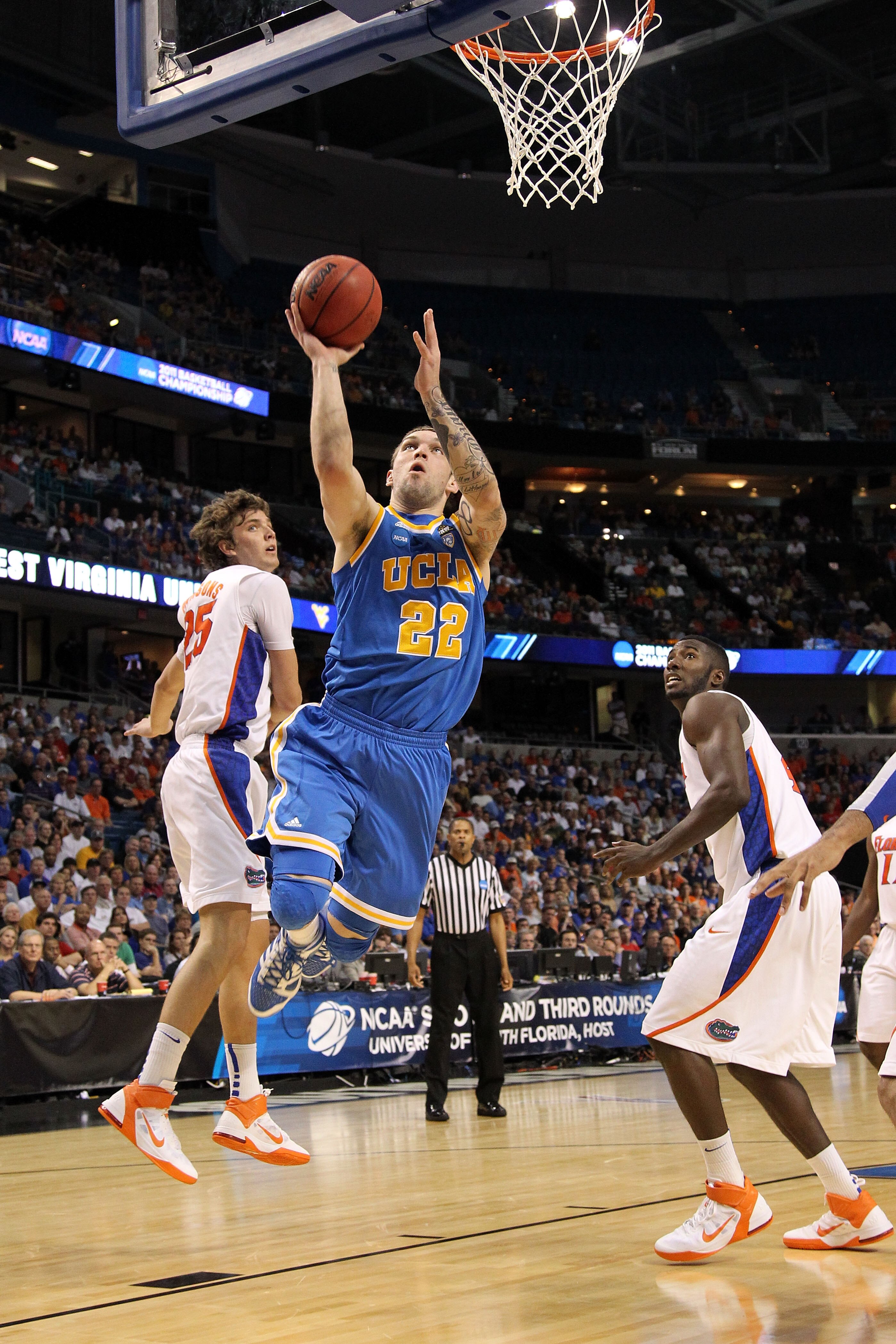 TAMPA, FL - MARCH 19:  Reeves Nelson #22 of the UCLA Bruins drives for a shot attempt against Chandler Parsons #25 and Patric Young #4 of the Florida Gators during the third round of the 2011 NCAA men's basketball tournament at St. Pete Times Forum on Mar