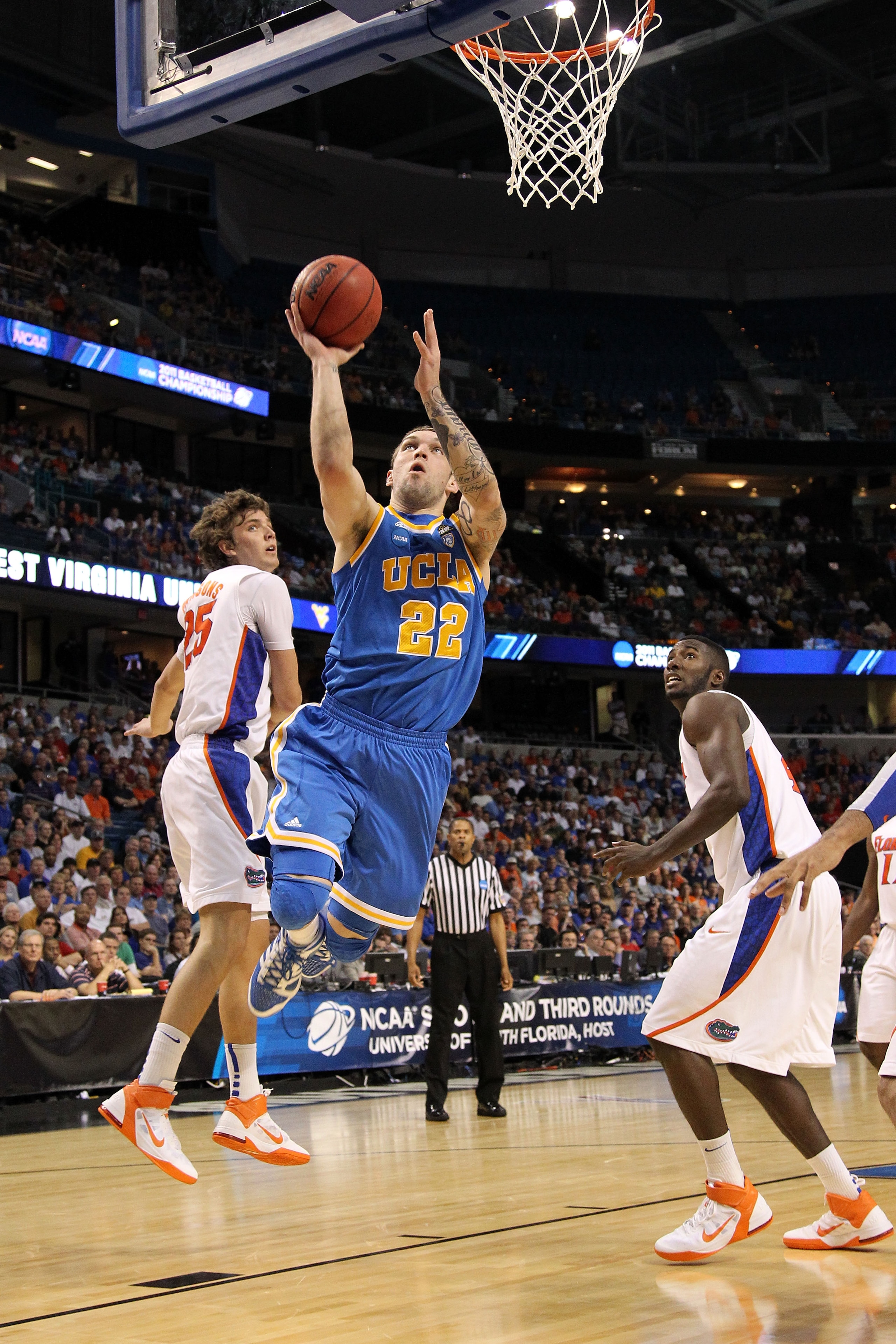 TAMPA, FL - MARCH 19:  Reeves Nelson #22 of the UCLA Bruins drives for a shot attempt against Chandler Parsons #25 and Patric Young #4 of the Florida Gators during the third round of the 2011 NCAA men's basketball tournament at St. Pete Times Forum on Mar