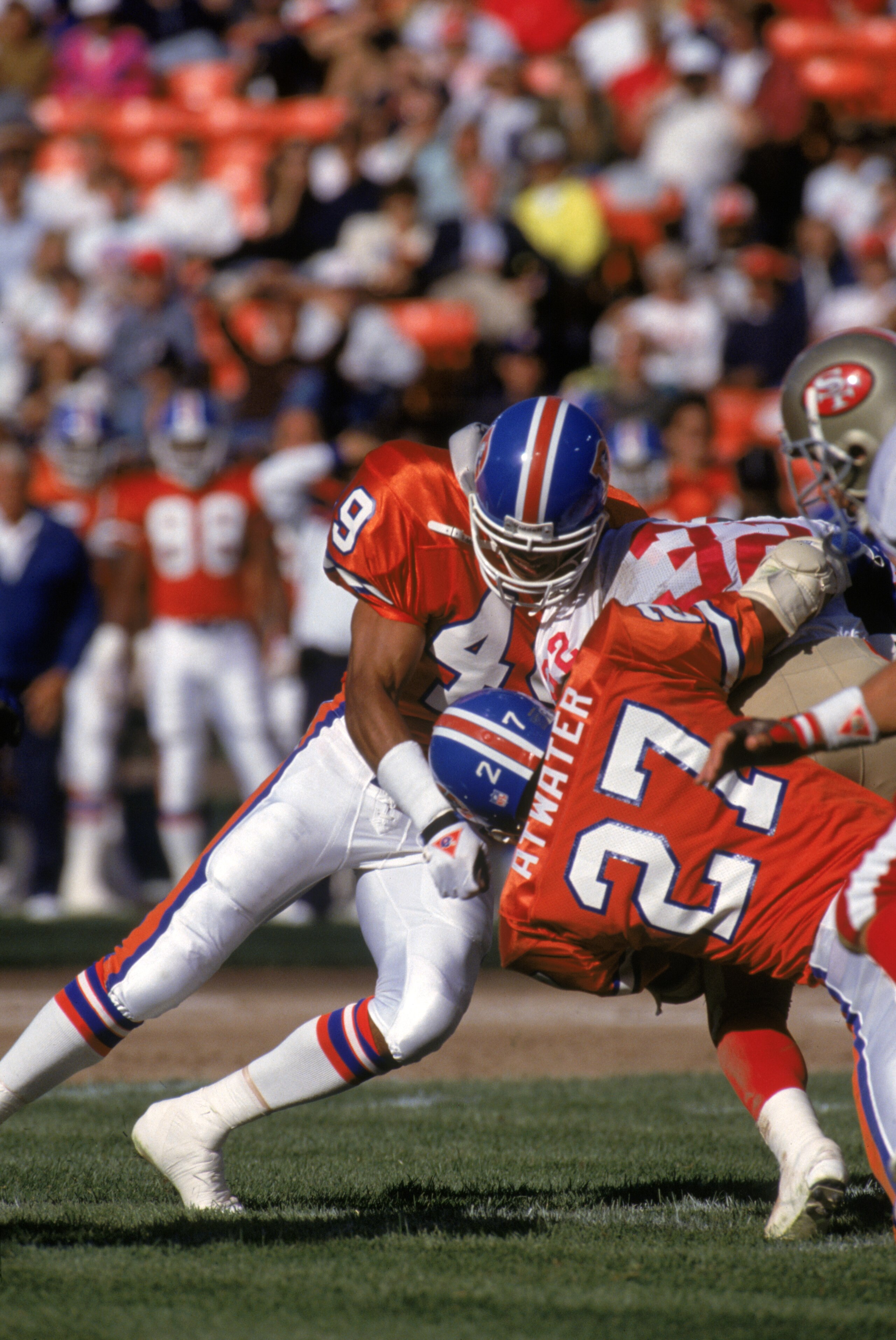 SAN FRANCISCO - AUGUST 3: Safeties Dennis Smith #49 and Steve Atwater #27 of the Denver Broncos team up for a tackle during pre season game against the San Francisco 49ers at Candlestick Park on August 3, 1992 in San Francisco, California. The 49ers won SAN FRANCISCO - AUGUST 3: Safeties Dennis Smith #49 and Steve Atwater #27 of the Denver Broncos team up for a tackle during pre season game against the San Francisco 49ers at Candlestick Park on August 3, 1992 in San Francisco, California. The 49ers won