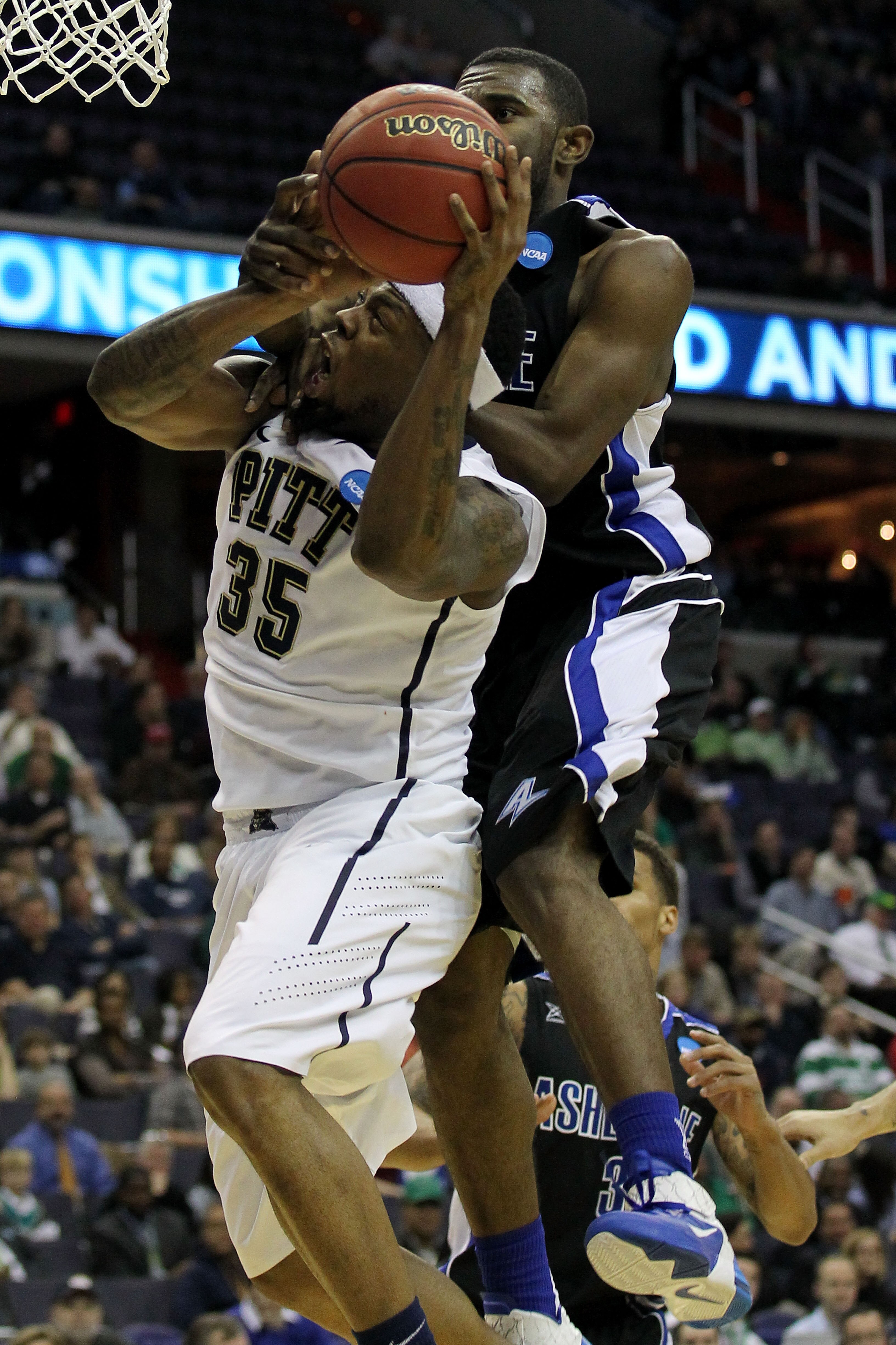 WASHINGTON - MARCH 17:  Nasir Robinson #35 of the Pittsburgh Panthers drives to the hoop against Quinard Jackson #32 of the North Carolina-Asheville Bulldogs during the second round of the 2011 NCAA men's basketball tournament at the Verizon Center on Mar