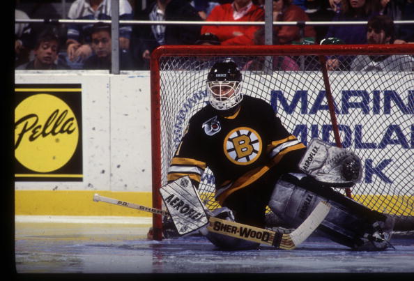 REGGIE LEMELIN OF THE BOSTON BRUINS SLIDES HIS BODY TO BLOCK HIS GOAL IN A GAME AGAINST THE BUFFALO SABRES