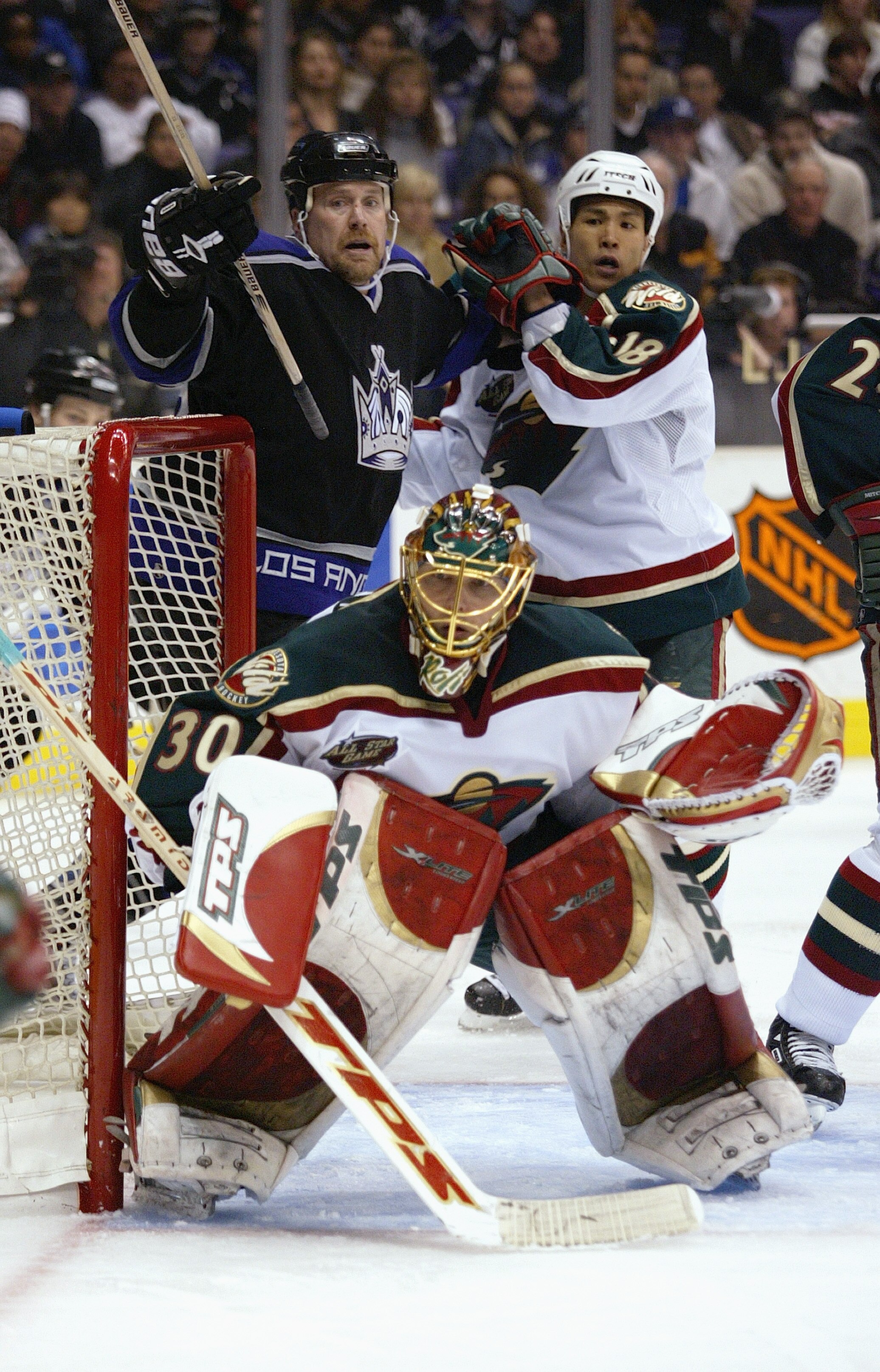 LOS ANGELES - MARCH 4:  Goalie Dwayne Roloson #30 of the Minnesota Wild protects the net during the game against the Los Angeles Kings at Staples Center on March 4, 2004 in Los Angeles, California. The Wild and the Kings skated to a 1-1 tie. (Photo by Dou