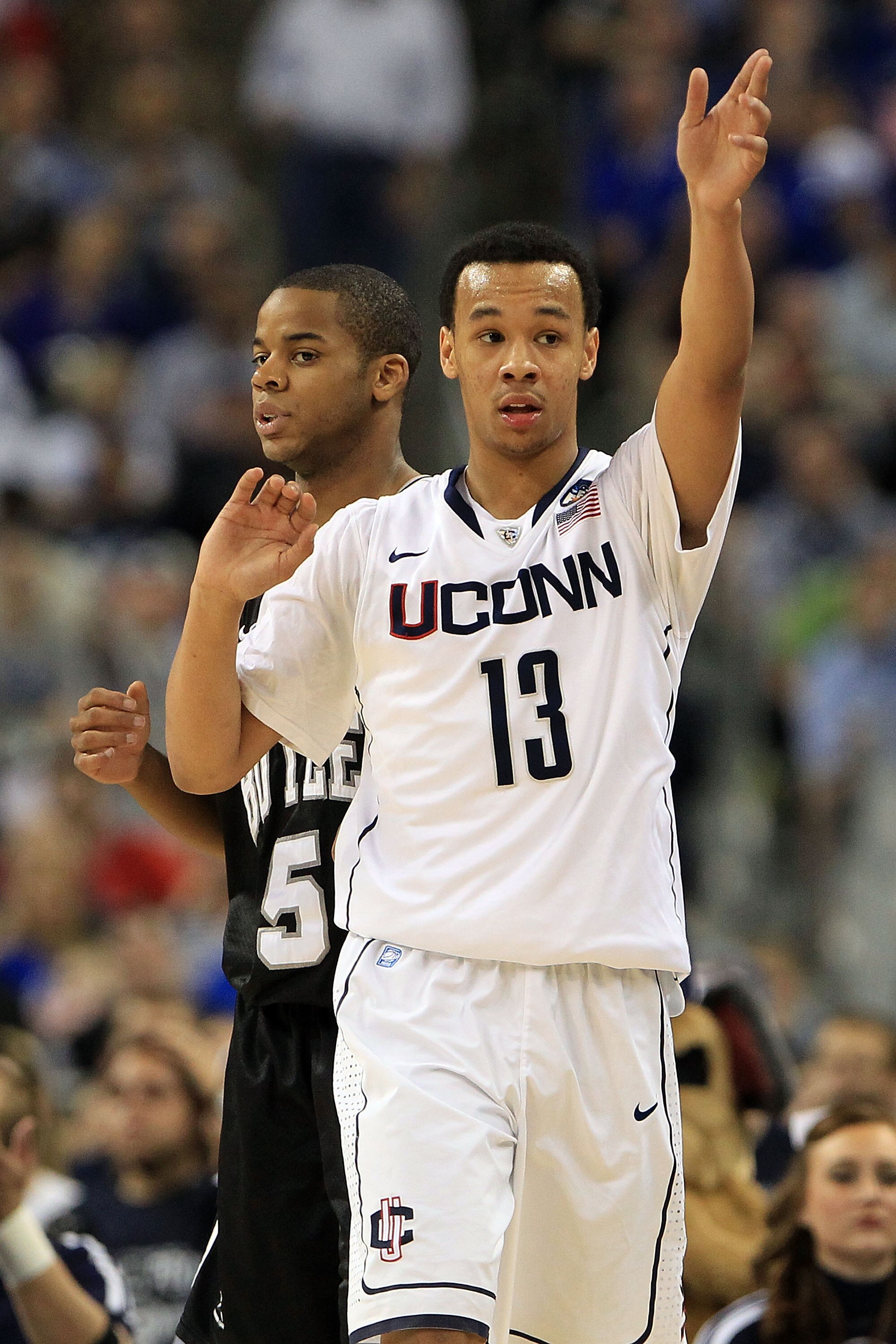HOUSTON, TX - APRIL 04:  Shabazz Napier #13 of the Connecticut Huskies gestures against the Butler Bulldogs during the National Championship Game of the 2011 NCAA Division I Men's Basketball Tournament at Reliant Stadium on April 4, 2011 in Houston, Texas