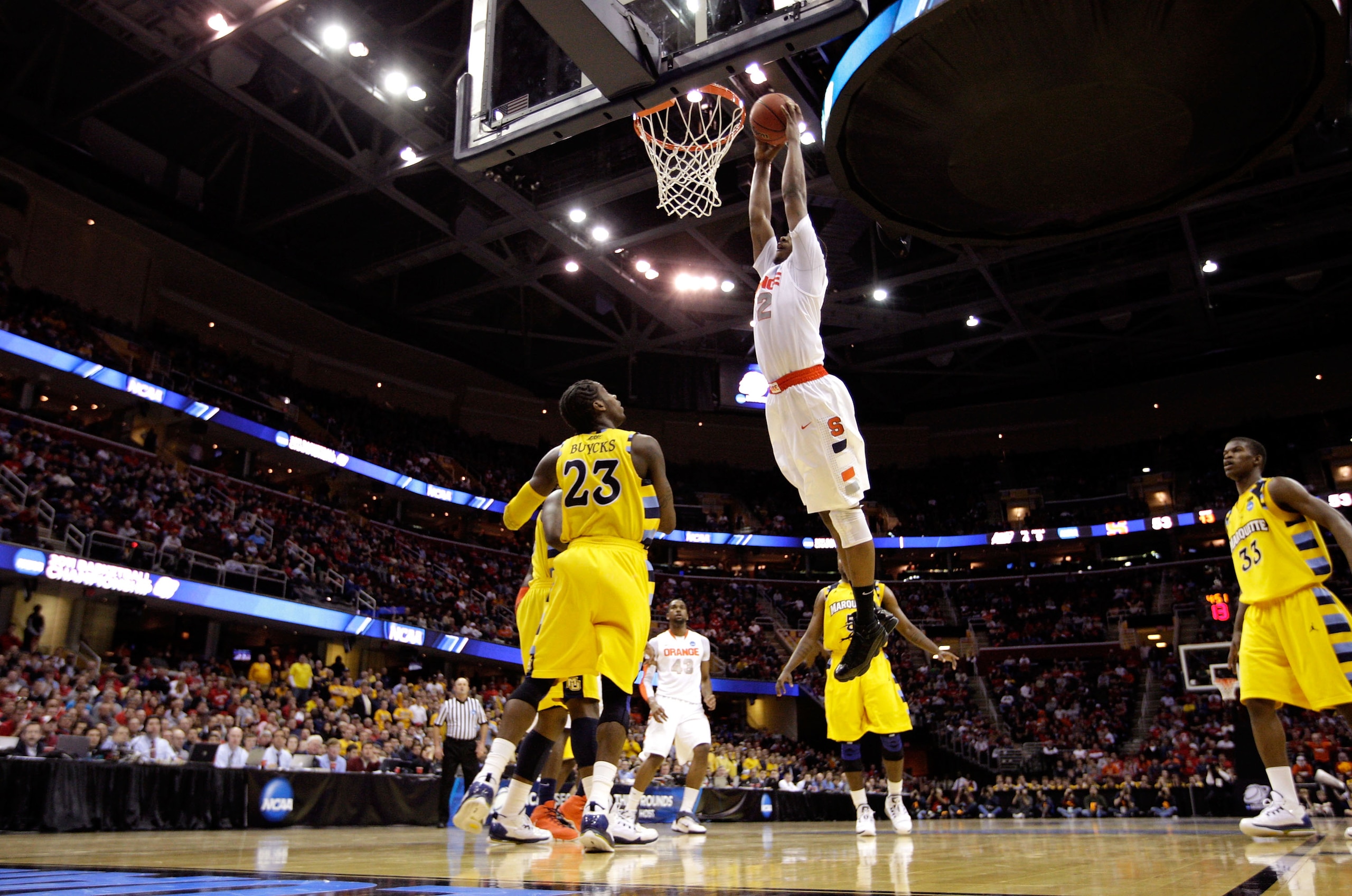 CLEVELAND, OH - MARCH 20: Kris Joseph #32 of the Syracuse Orange drives to the basket against Dwight Buycks #23 of the Marquette Golden Eagles during the third of the 2011 NCAA men's basketball tournament at Quicken Loans Arena on March 20, 2011 in Clevel