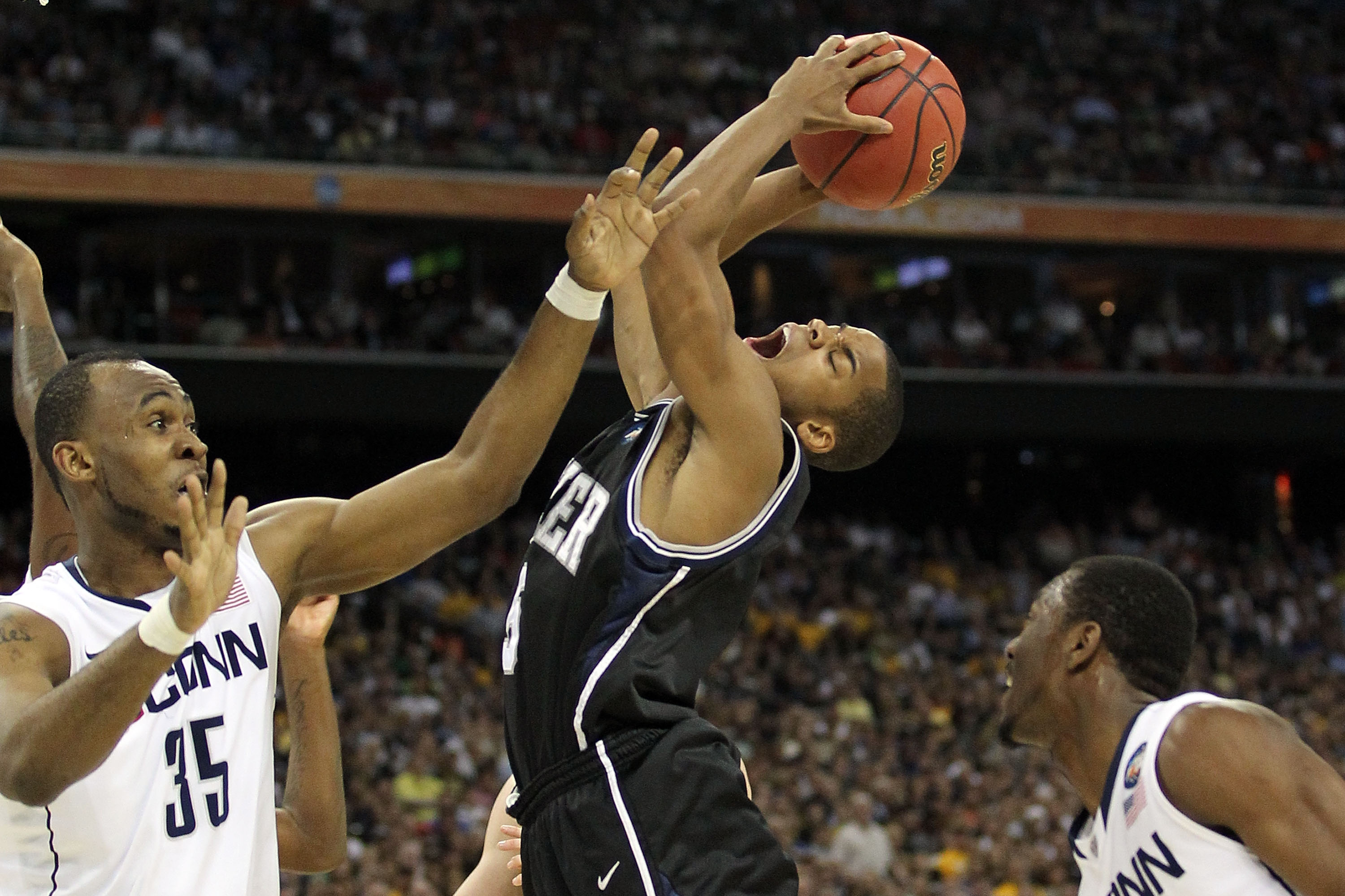 HOUSTON, TX - APRIL 04:  Ronald Nored #5 of the Butler Bulldogs draws contact against Charles Okwandu #35 of the Connecticut Huskies during the National Championship Game of the 2011 NCAA Division I Men's Basketball Tournament at Reliant Stadium on April