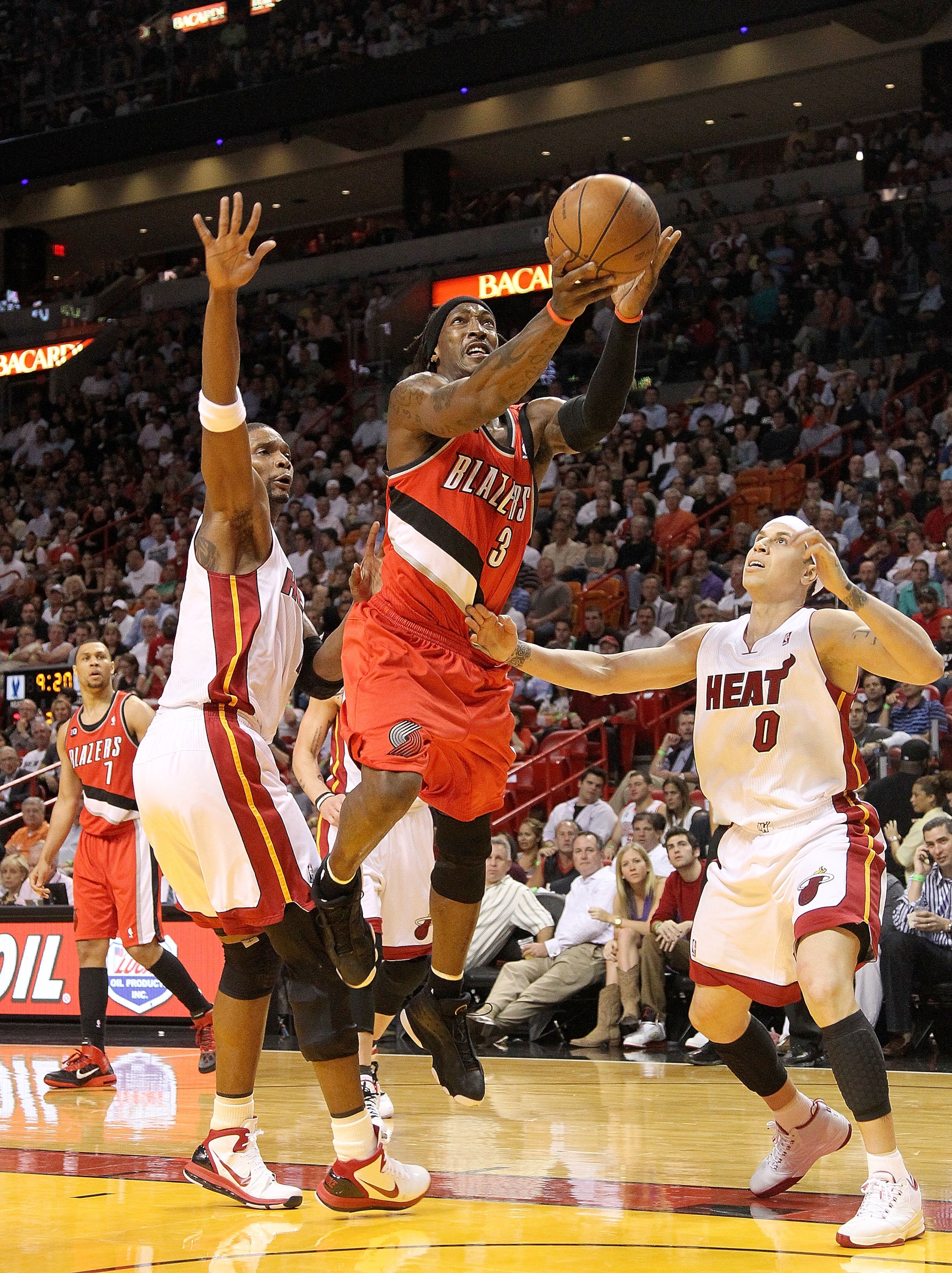 MIAMI, FL - MARCH 08: Gerald Wallace #3 of the Portland Trail Blazers splits through Chris Bosh #1 and Mike Bibby #0 of the Miami Heat during a game at American Airlines Arena on March 8, 2011 in Miami, Florida. NOTE TO USER: User expressly acknowledges a MIAMI, FL - MARCH 08: Gerald Wallace #3 of the Portland Trail Blazers splits through Chris Bosh #1 and Mike Bibby #0 of the Miami Heat during a game at American Airlines Arena on March 8, 2011 in Miami, Florida. NOTE TO USER: User expressly acknowledges a