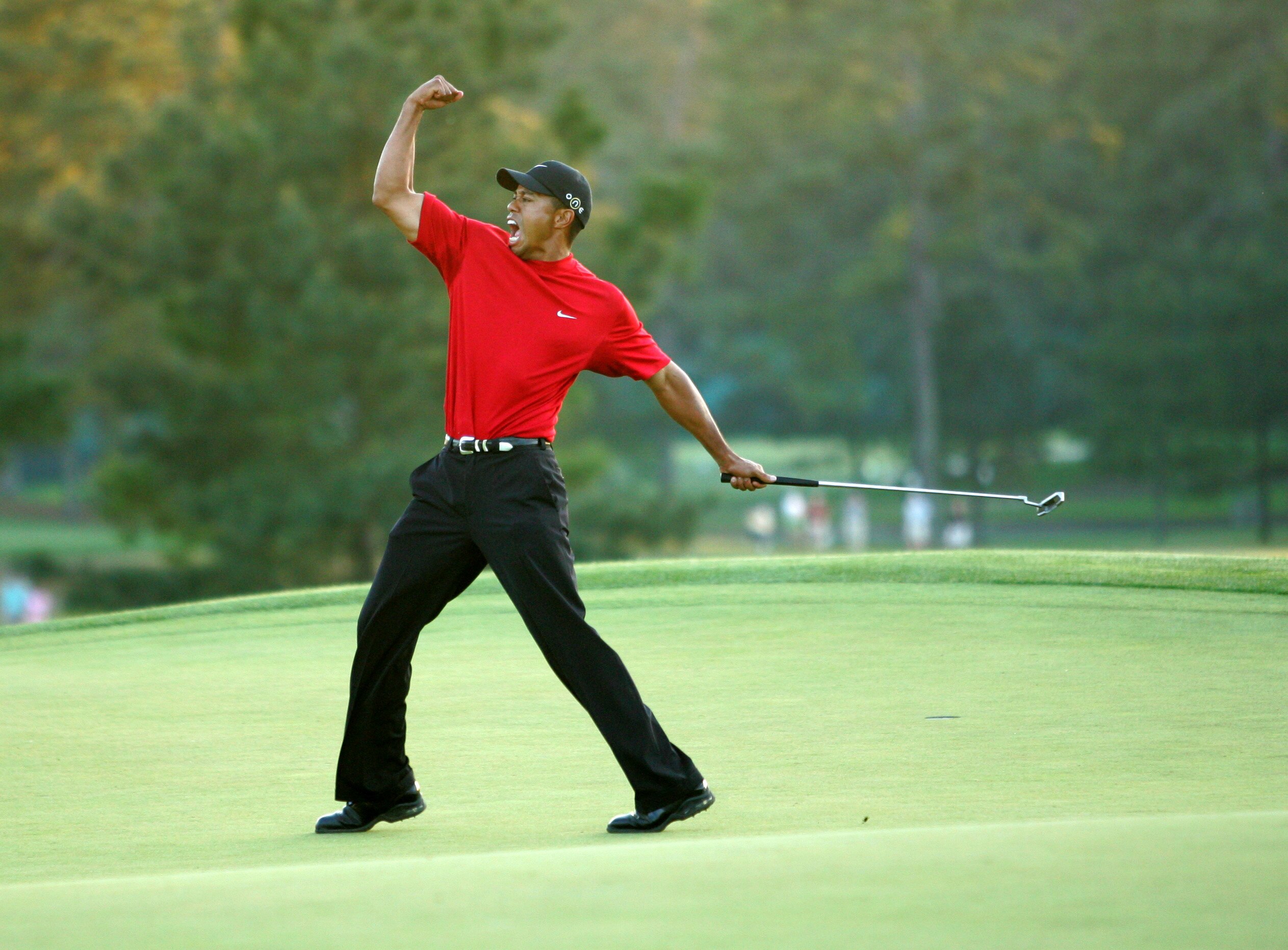 AUGUSTA, GA - APRIL 10:  Tiger Woods celebrates after sinking a putt on the first playoff hole to win the 2005 Masters on April 10, 2005 at Augusta National Golf Course in Augusta, Georgia.  (Photo By Getty Images)