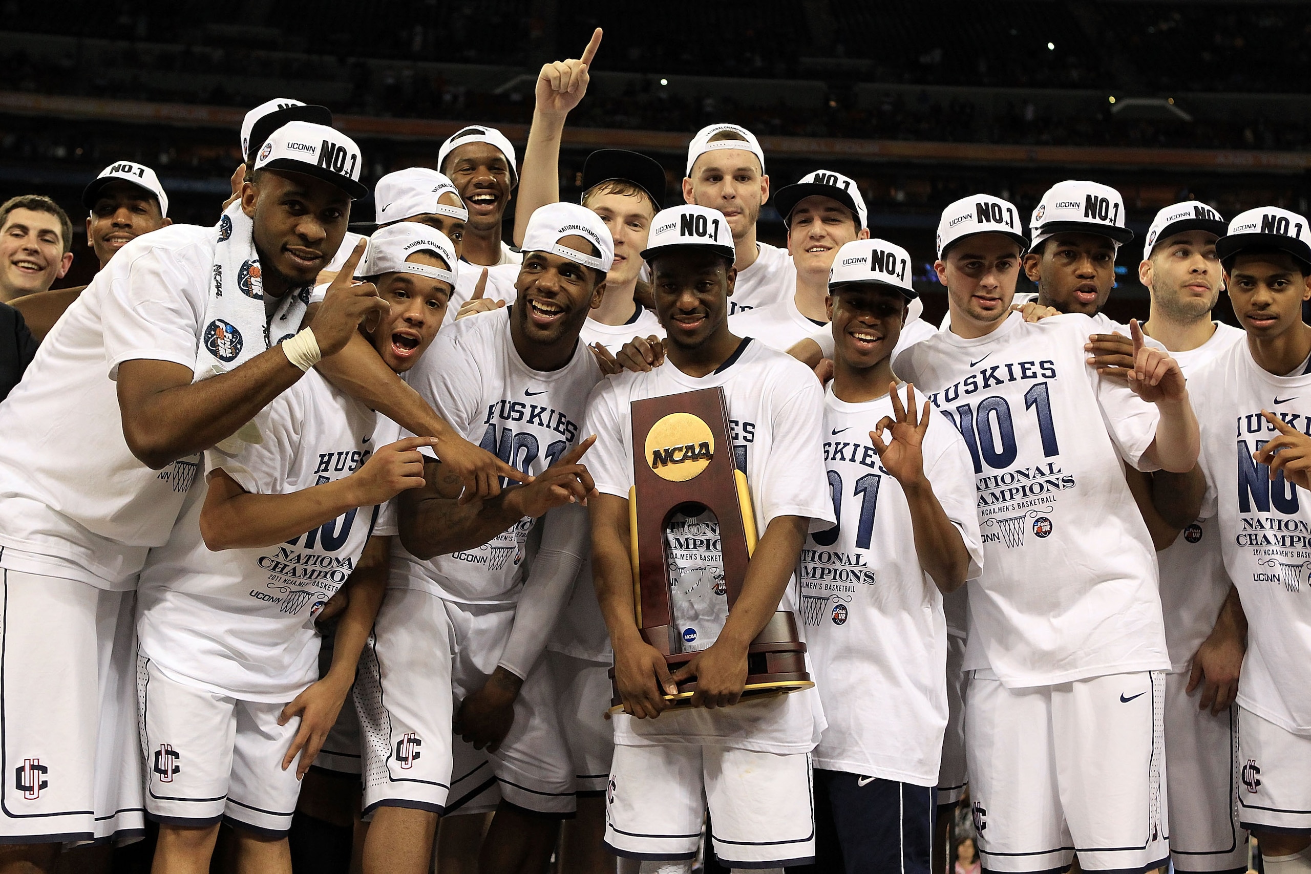 HOUSTON, TX - APRIL 04: Kemba Walker #15 of the Connecticut Huskies holds the trophy as he and his team celebrate after defeating the Butler Bulldogs to win the National Championship Game of the 2011 NCAA Division I Men's Basketball Tournament by a score HOUSTON, TX - APRIL 04: Kemba Walker #15 of the Connecticut Huskies holds the trophy as he and his team celebrate after defeating the Butler Bulldogs to win the National Championship Game of the 2011 NCAA Division I Men's Basketball Tournament by a score