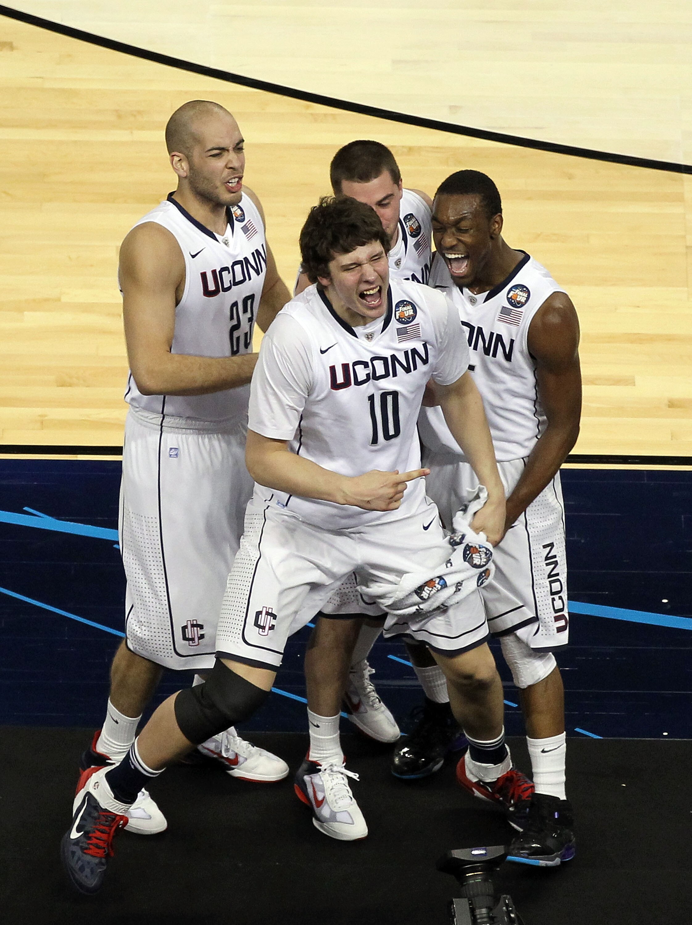 HOUSTON, TX - APRIL 04:  Kemba Walker #15, Benjamin Stewart #23, Tyler Olander #10 and Kyle Bailey #21 of the Connecticut Huskies react after defeating the Butler Bulldogs to win the National Championship Game of the 2011 NCAA Division I Men's Basketball 