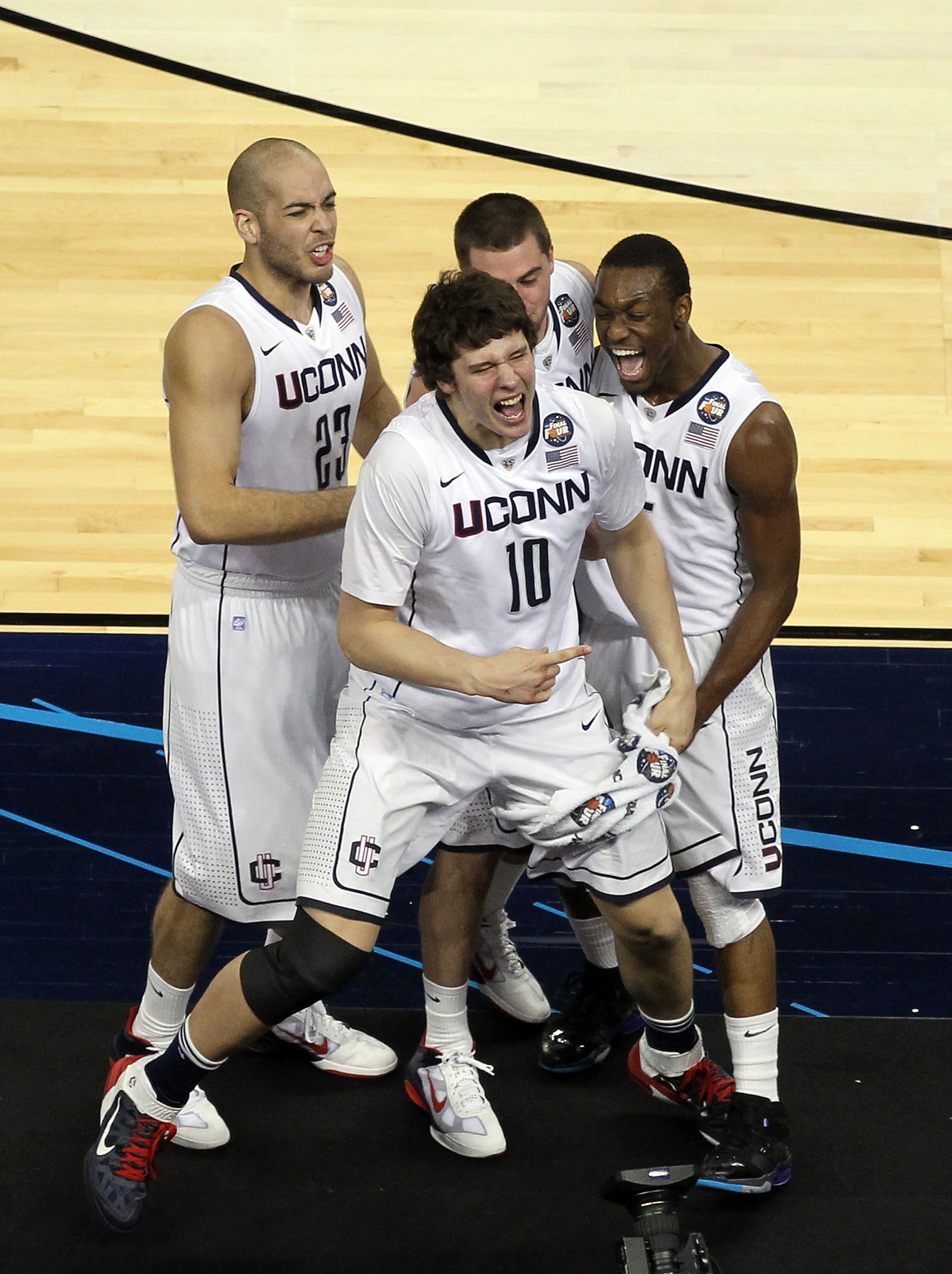 HOUSTON, TX - APRIL 04:  Kemba Walker #15, Benjamin Stewart #23, Tyler Olander #10 and Kyle Bailey #21 of the Connecticut Huskies react after defeating the Butler Bulldogs to win the National Championship Game of the 2011 NCAA Division I Men's Basketball 