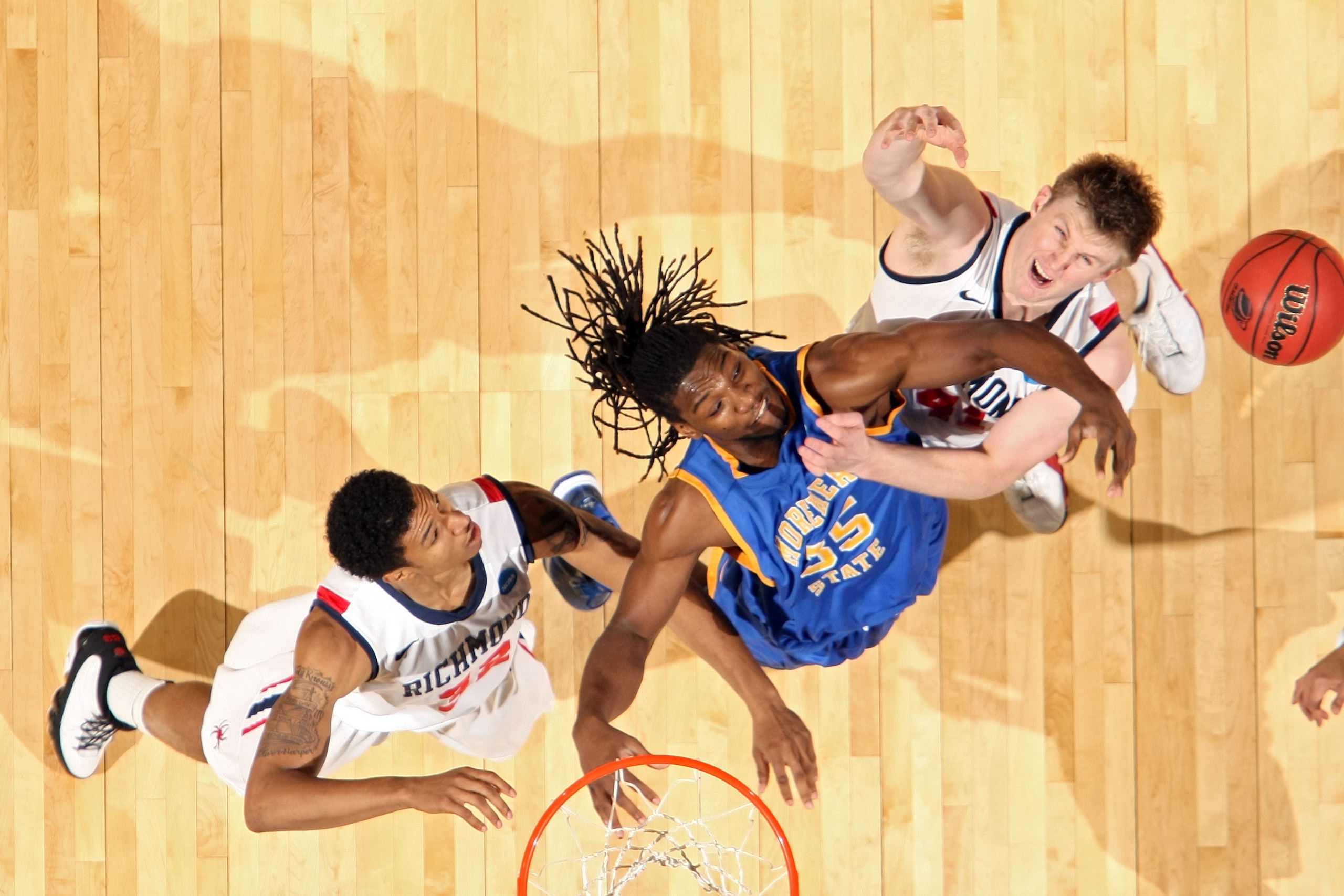 DENVER, CO - MARCH 19: Kenneth Faried #35 of the Morehead State Eagles fights for a loose ball against Justin Harper #32 and Dan Geriot #41 of the Richmond Spiders during the third round of the 2011 NCAA men's basketball tournament at Pepsi Center on Mar DENVER, CO - MARCH 19: Kenneth Faried #35 of the Morehead State Eagles fights for a loose ball against Justin Harper #32 and Dan Geriot #41 of the Richmond Spiders during the third round of the 2011 NCAA men's basketball tournament at Pepsi Center on Mar