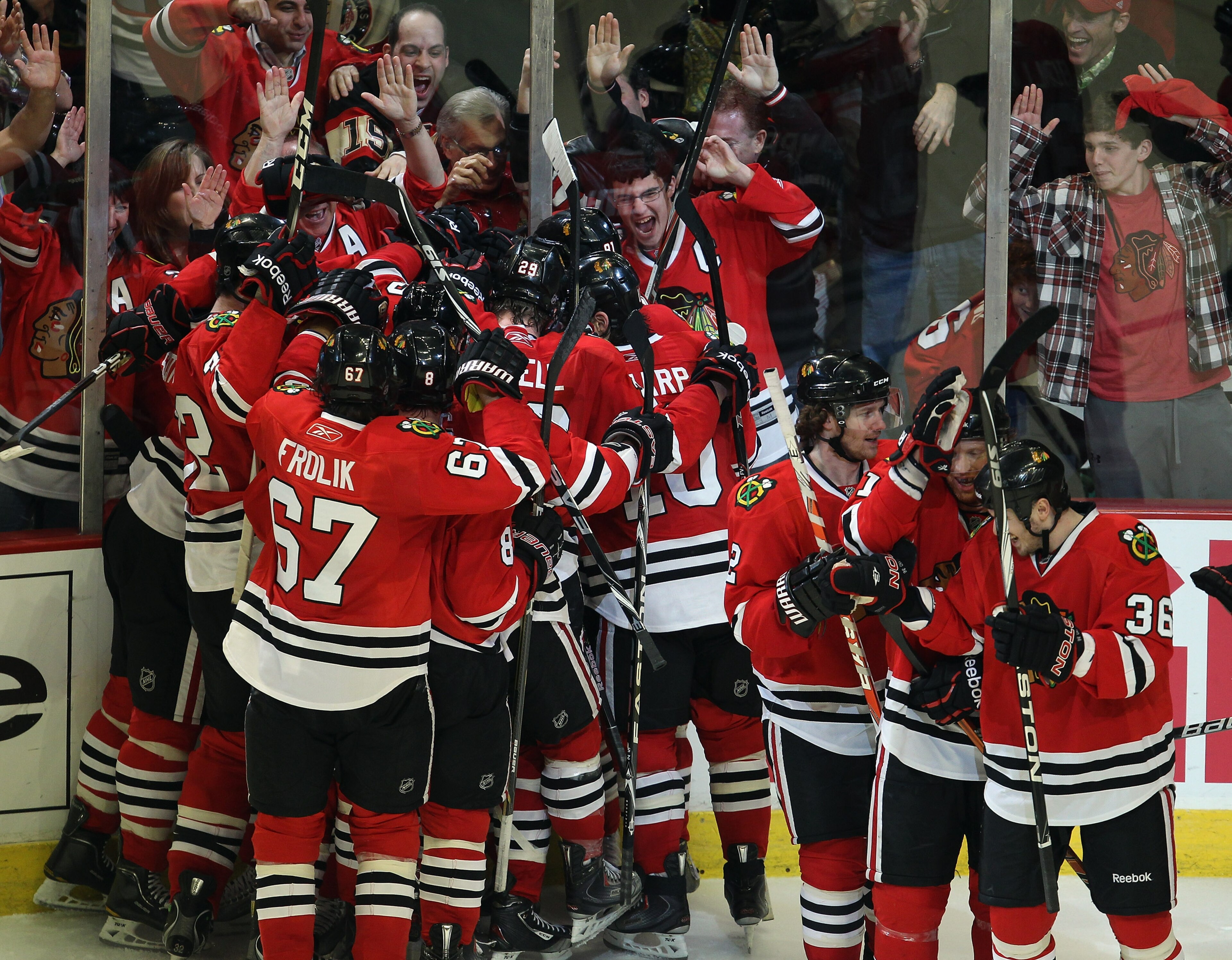 CHICAGO, IL - APRIL 24: Members of the Chicago Blackhawks celebrate an overtime win against the Vancouver Canucks in Game Six of the Western Conference Quarterfinals during the 2011 NHL Stanley Cup Playoffs at the United Center on April 24, 2011 in Chicag CHICAGO, IL - APRIL 24: Members of the Chicago Blackhawks celebrate an overtime win against the Vancouver Canucks in Game Six of the Western Conference Quarterfinals during the 2011 NHL Stanley Cup Playoffs at the United Center on April 24, 2011 in Chicag