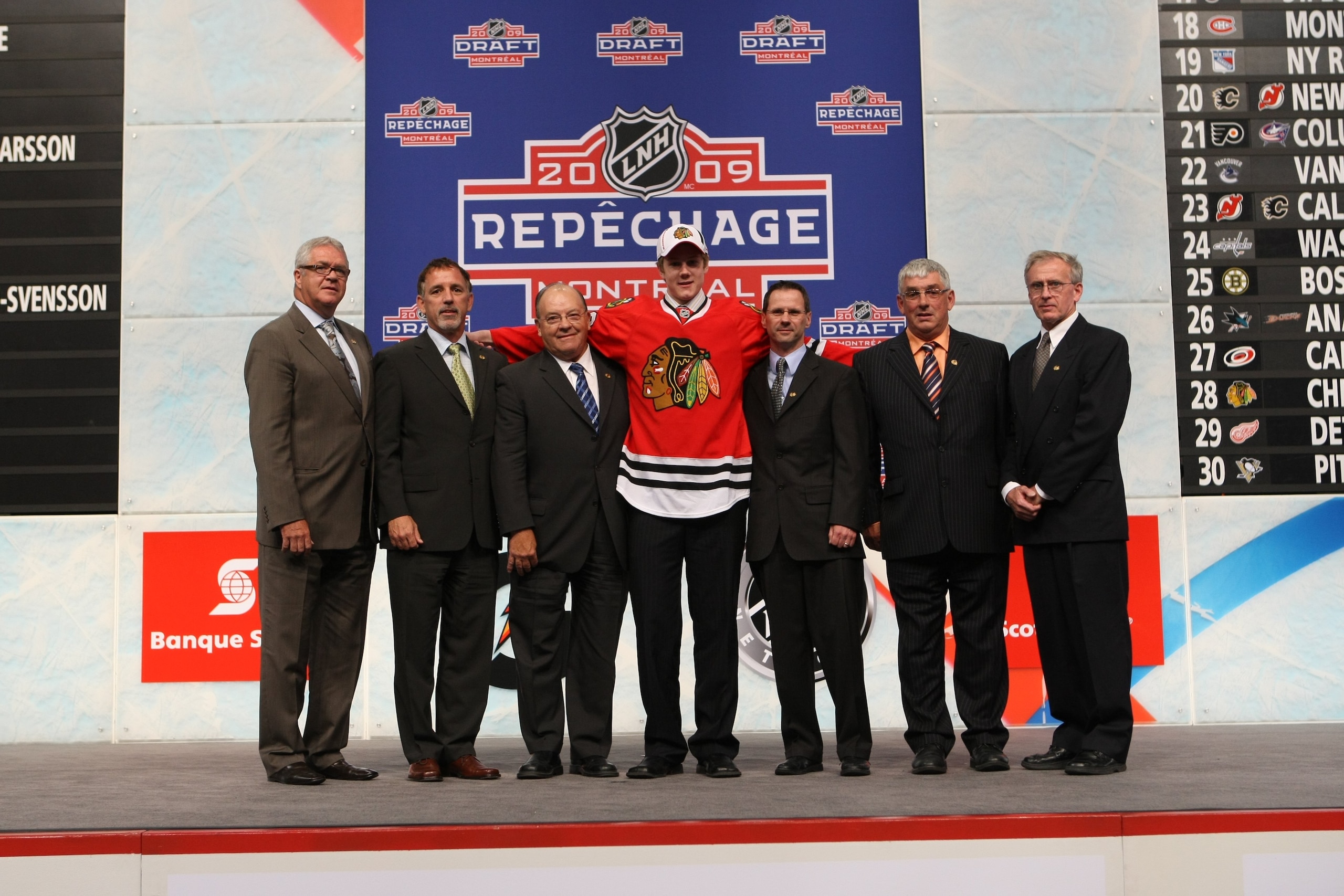 MONTREAL - JUNE 26:  Dylan Olsen poses with members of the Chicago Blackhawks organization after being drafted during the first round of the 2009 NHL Entry Draft at the Bell Centre on June 26, 2009 in Montreal, Quebec, Canada. (Photo by Bruce Bennett/Gett