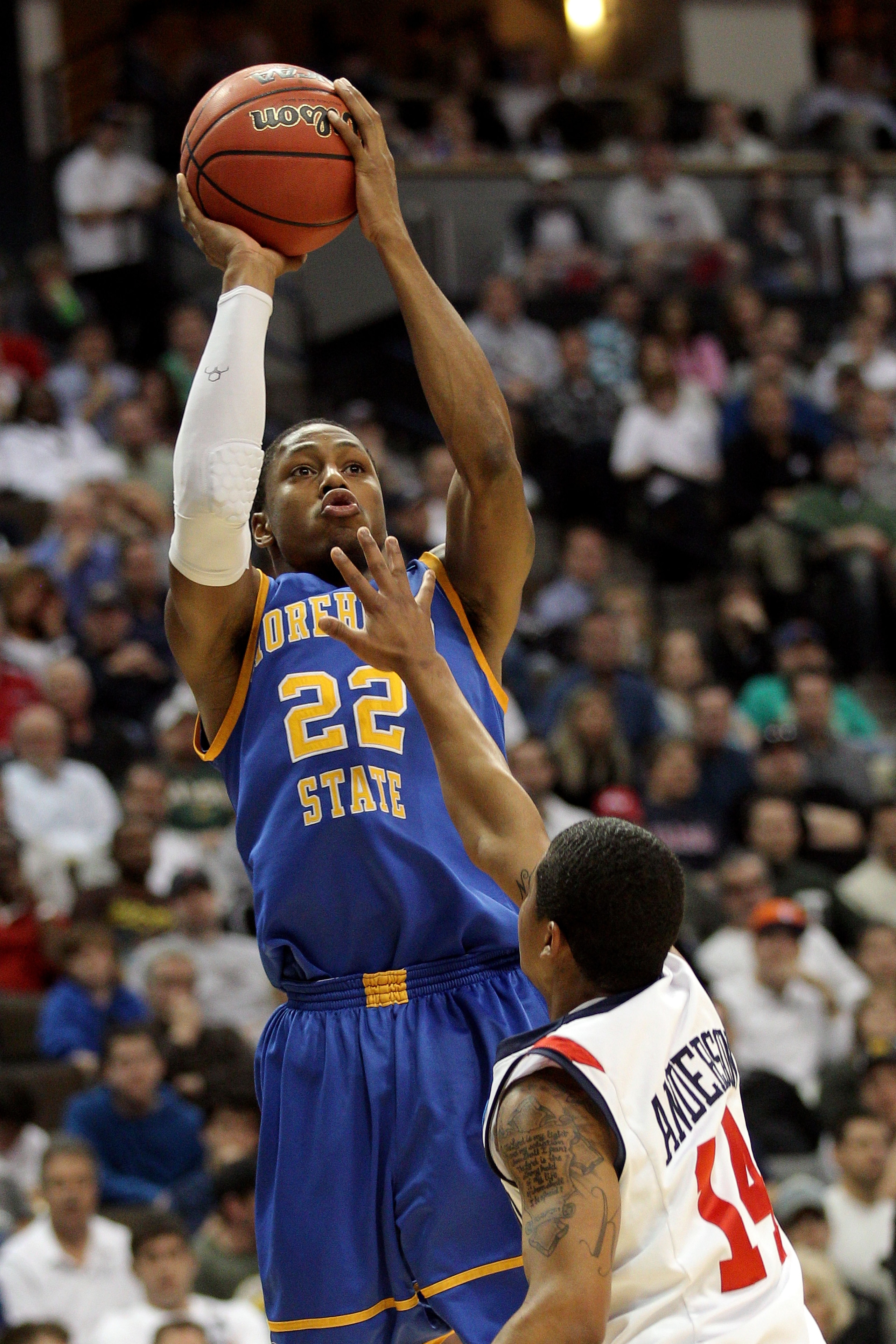 DENVER, CO - MARCH 19: Demonte Harper #22 of the Morehead State Eagles shoot over Kevin Anderson #14 of the Richmond Spiders during the third round of the 2011 NCAA men's basketball tournament at Pepsi Center on March 19, 2011 in Denver, Colorado. (Phot DENVER, CO - MARCH 19: Demonte Harper #22 of the Morehead State Eagles shoot over Kevin Anderson #14 of the Richmond Spiders during the third round of the 2011 NCAA men's basketball tournament at Pepsi Center on March 19, 2011 in Denver, Colorado. (Phot