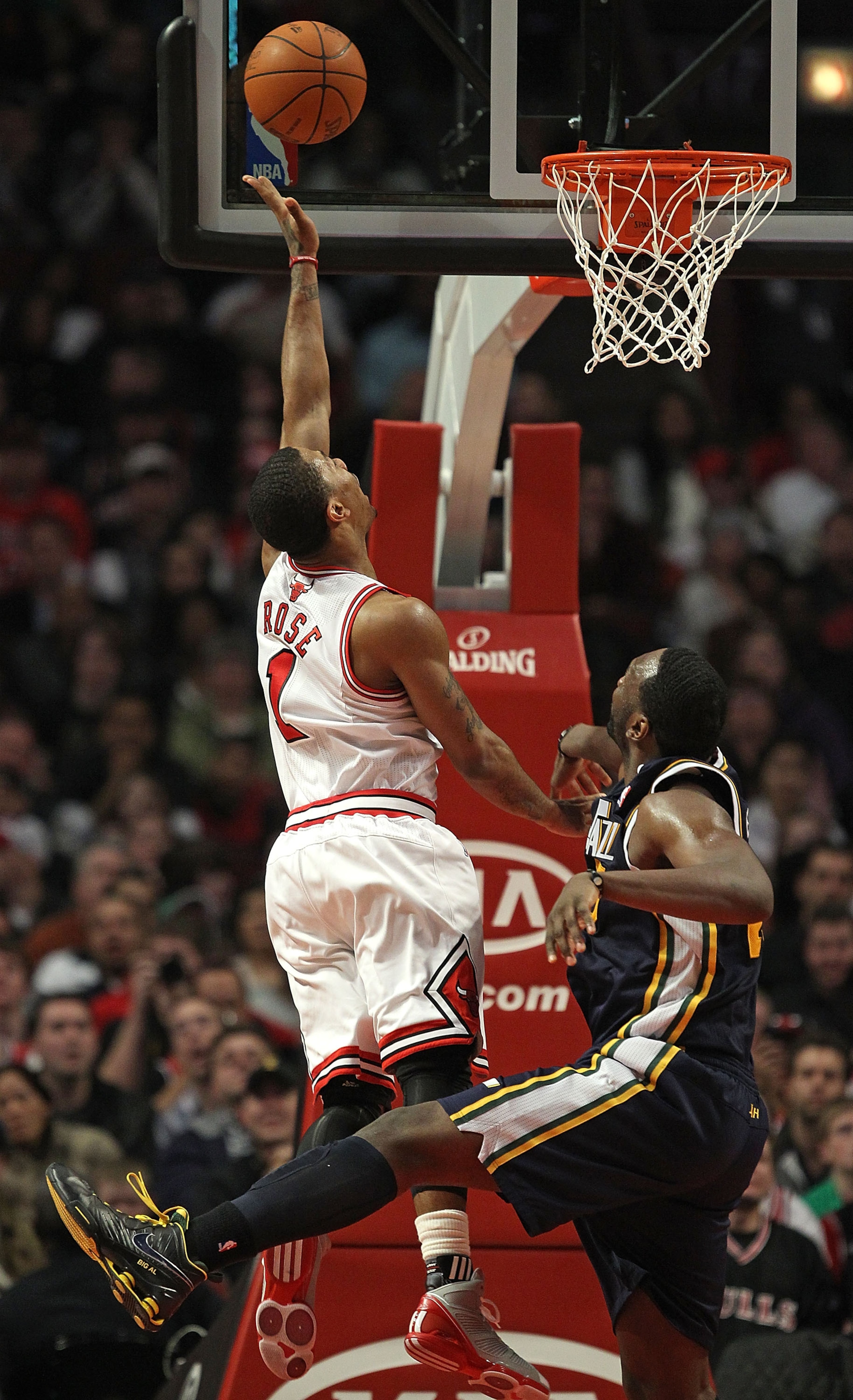 CHICAGO, IL - MARCH 12: Derrick Rose #1 of the Chicago Bulls puts up a shot over Al Jefferson #25 of the Utah Jazz at the United Center on March 12, 2011 in Chicago, Illinois. The Bulls defeated the Jazz 118-100. NOTE TO USER: User expressly acknowledges CHICAGO, IL - MARCH 12: Derrick Rose #1 of the Chicago Bulls puts up a shot over Al Jefferson #25 of the Utah Jazz at the United Center on March 12, 2011 in Chicago, Illinois. The Bulls defeated the Jazz 118-100. NOTE TO USER: User expressly acknowledges