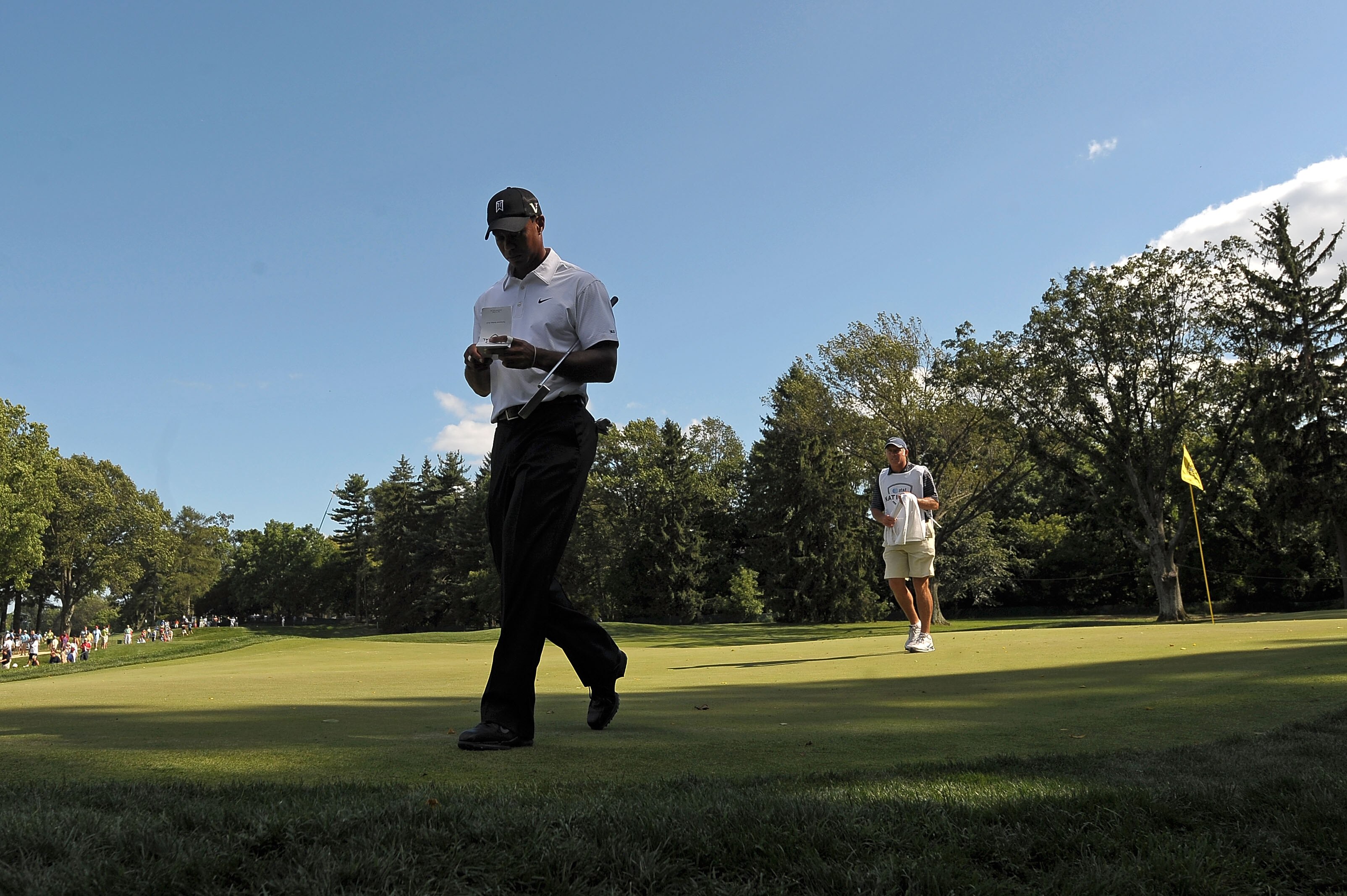 NEWTOWN SQUARE, PA - JULY 01:  Tiger Woods checks his scorecard as he walks off the 14th green ahead of his caddie Steve Williams during the first round of the AT&T National at Aronimink Golf Club on July 1, 2010 in Newtown Square, Pennsylvania.  (Photo b