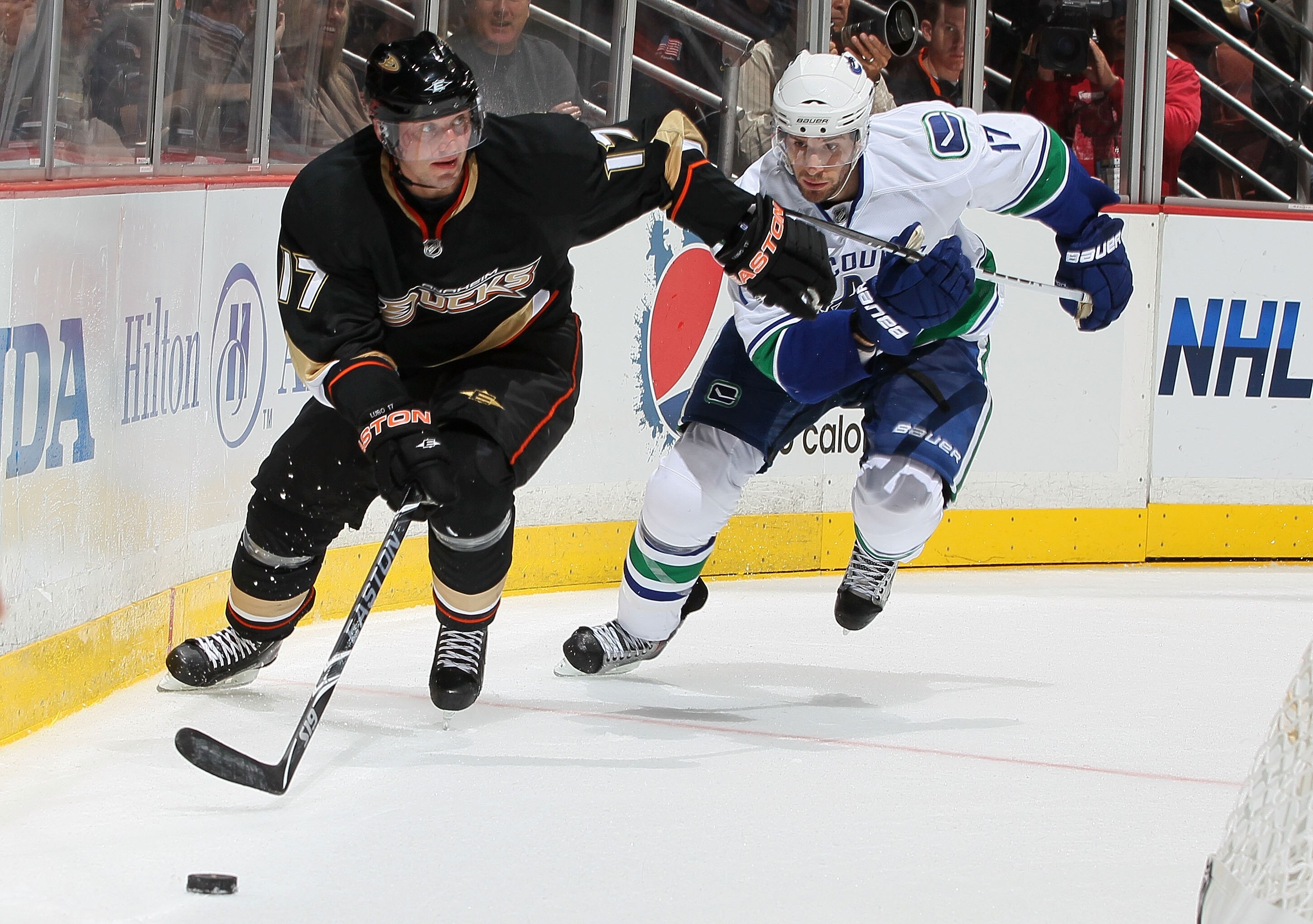 ANAHEIM, CA - OCTOBER 13:  Lubomir Visnovsky #17 of the Anaheim Ducks controls the puck as Ryan Kesler #17 of the Vancouver Canucks chases during their game at Honda Center on October 13, 2010 in Anaheim, California.  (Photo by Jeff Gross/Getty Images)