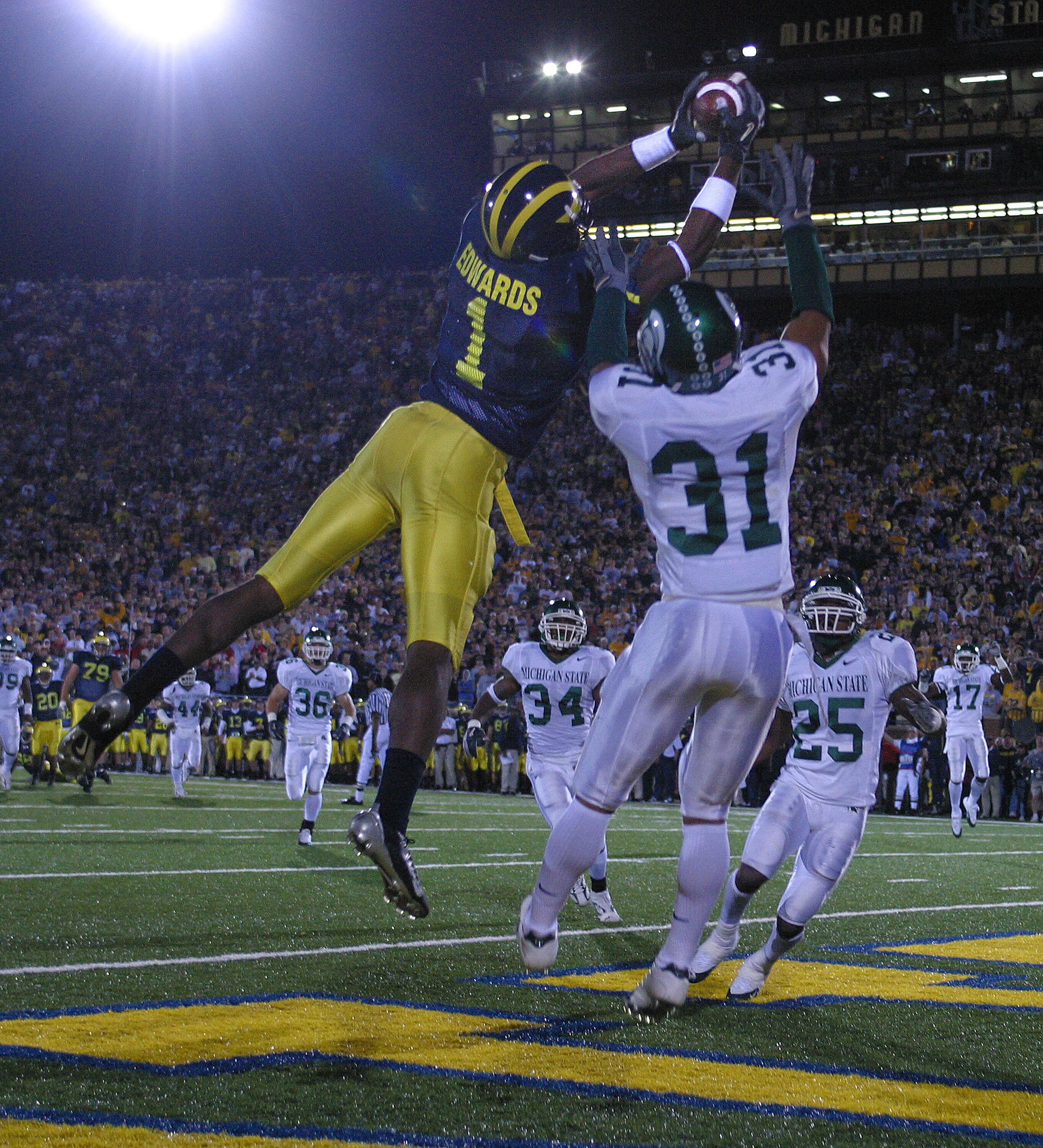 ANN ARBOR - October 30:  Wide receiver Braylon Edwards #1 of Michigan catches a touchdown pass defended by Jaren Hayes #31 of Michigan State at Michigan Stadium on October 30, 2004 in Ann Arbor, Michigan.  The Michigan Wolverines defeated the Michigan Sta