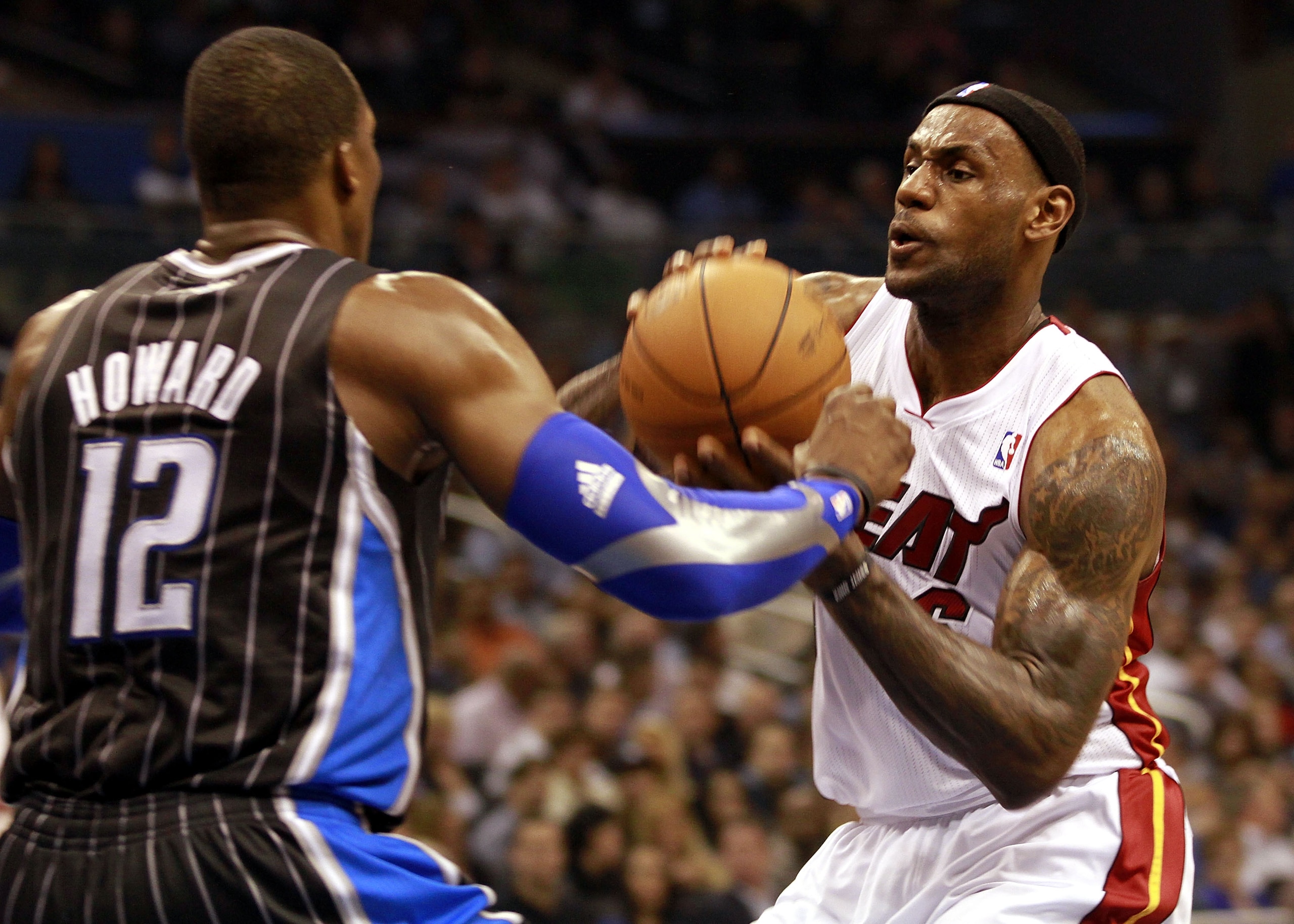 ORLANDO, FL - FEBRUARY 03:  Forward LeBron James #6 (R) of the Miami Heat drives against center Dwight Howard #12 of the Orlando Magic at Amway Arena on February 3, 2011 in Orlando, Florida. NOTE TO USER: User expressly acknowledges and agrees that, by do