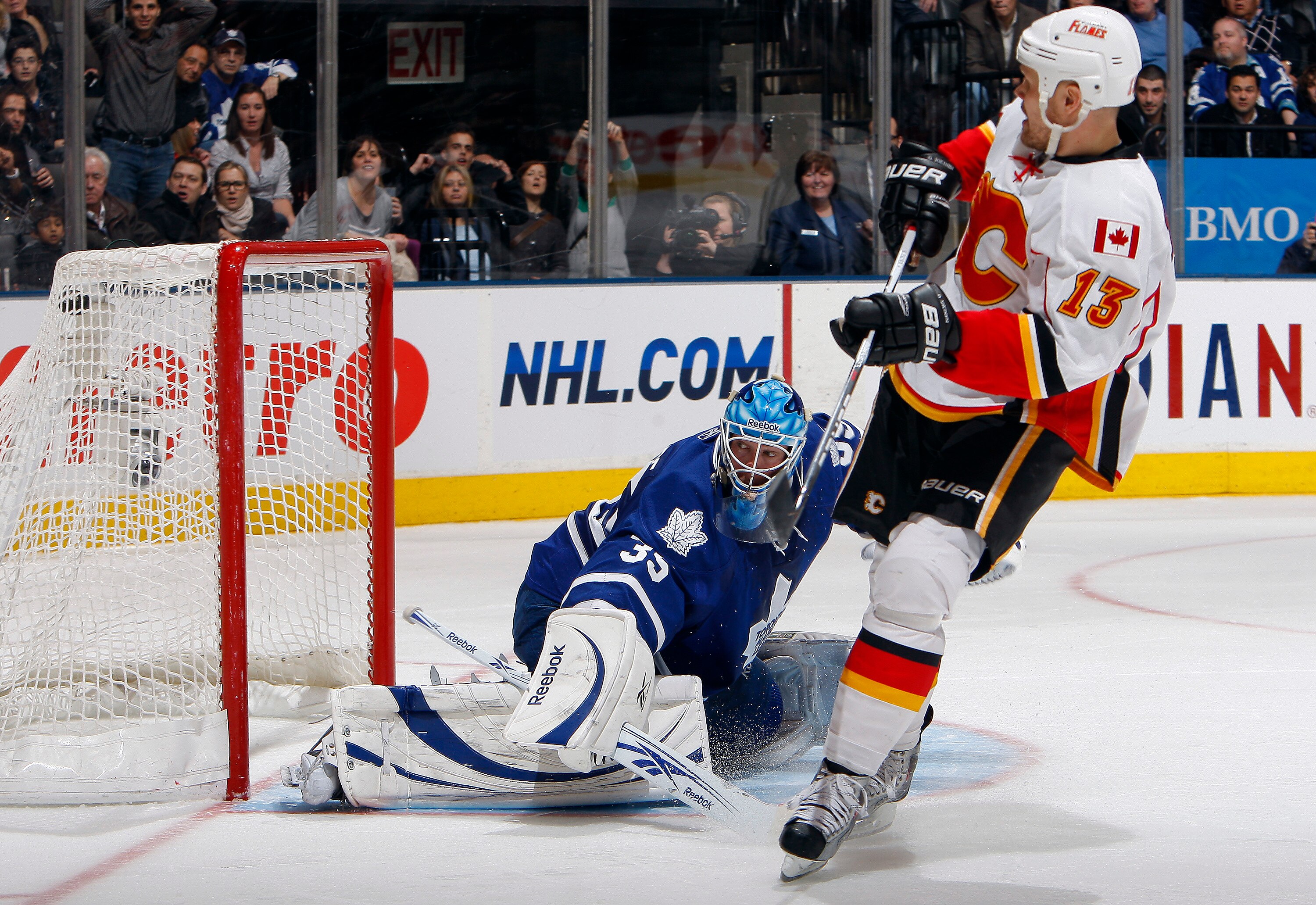 TORONTO, CANADA - JANUARY 15: Olli Jokinen #13 of the Calgary Flames scores the winner against Jean-Sebastien Giguere #35  of the Toronto Maple Leafs during the shootout at the Air Canada Centre January 15, 2011 in Toronto, Ontario, Canada. (Photo by Abel