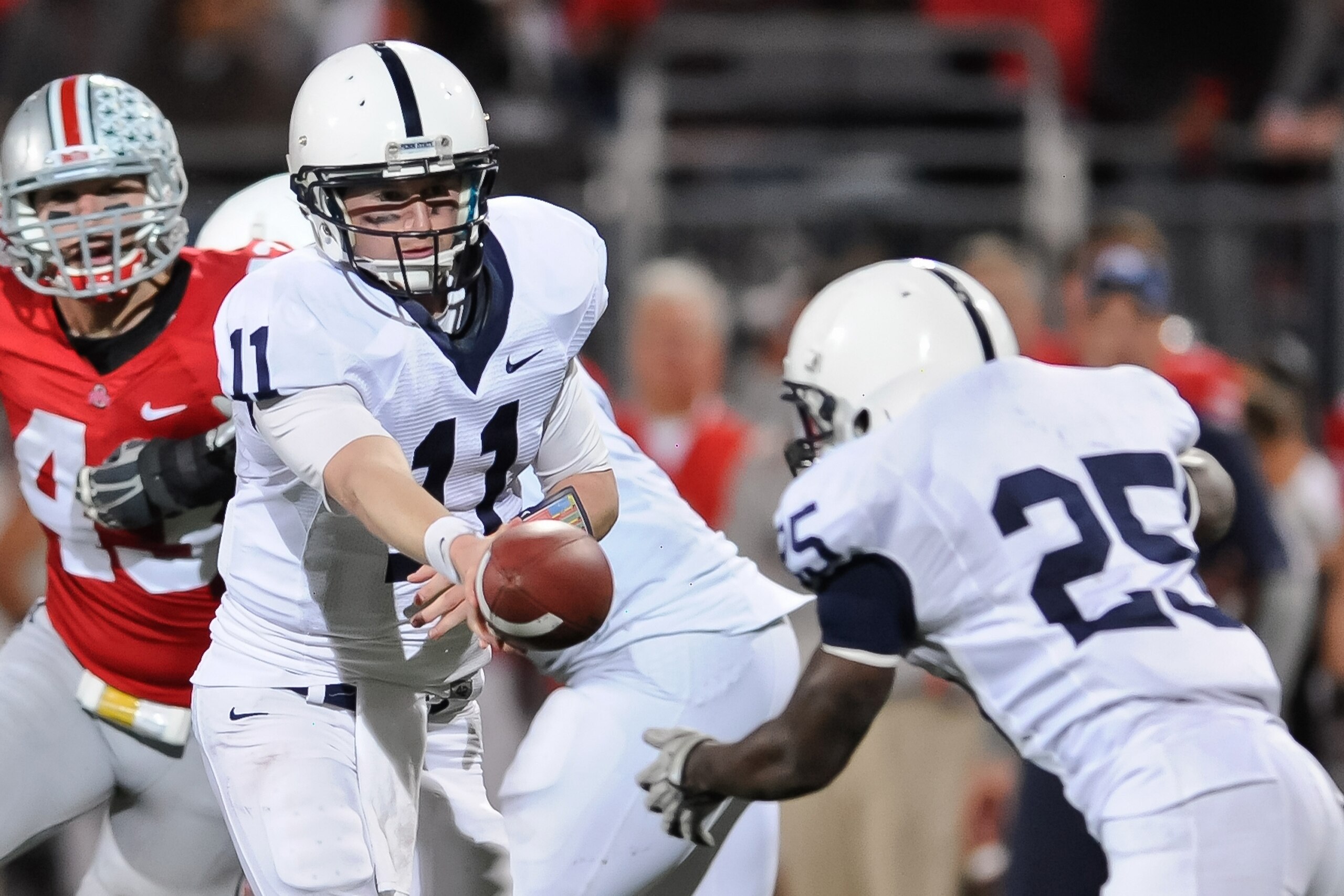 COLUMBUS, OH - NOVEMBER 13:  Quarterback Matt McGloin #11 of the Penn State Nittany Lions hands off against the Ohio State Buckeyes at Ohio Stadium on November 13, 2010 in Columbus, Ohio.  (Photo by Jamie Sabau/Getty Images)