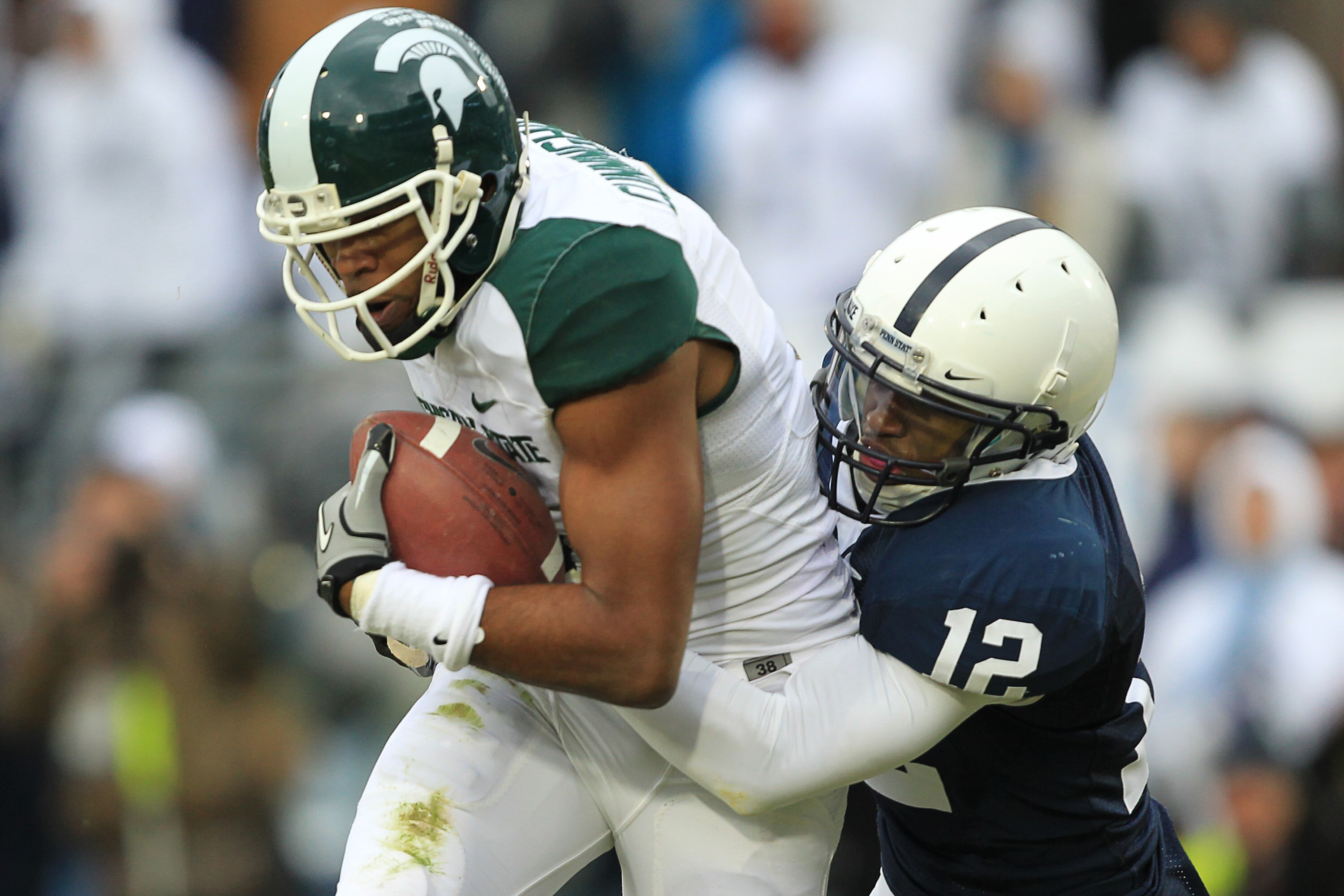 STATE COLLEGE, PA - NOVEMBER 27: Wide receiver B.J. Cunningham #3 of the Michigan State Spartans catches a touchdown pass as cornerback Stephon Morris #12 of the Penn State Nittany Lions defends during a game on November 27, 2010 at Beaver Stadium in Stat
