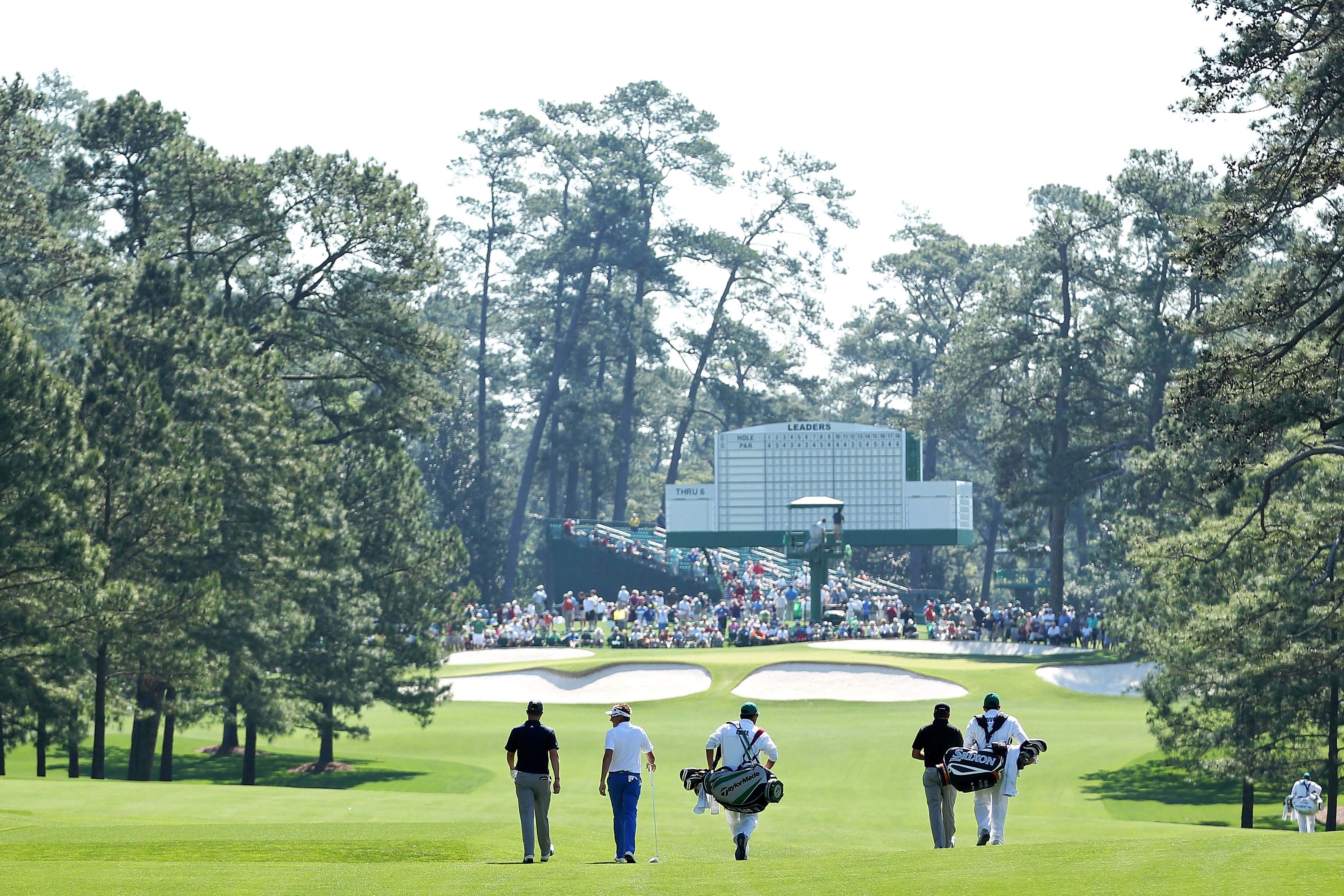 AUGUSTA, GA - APRIL 04:  Ian Poulter of England, Justin Rose of England and Graeme McDowell of Northern Ireland walk down a fairway with their caddies during a practice round prior to the 2011 Masters Tournament at Augusta National Golf Club on April 4, 2