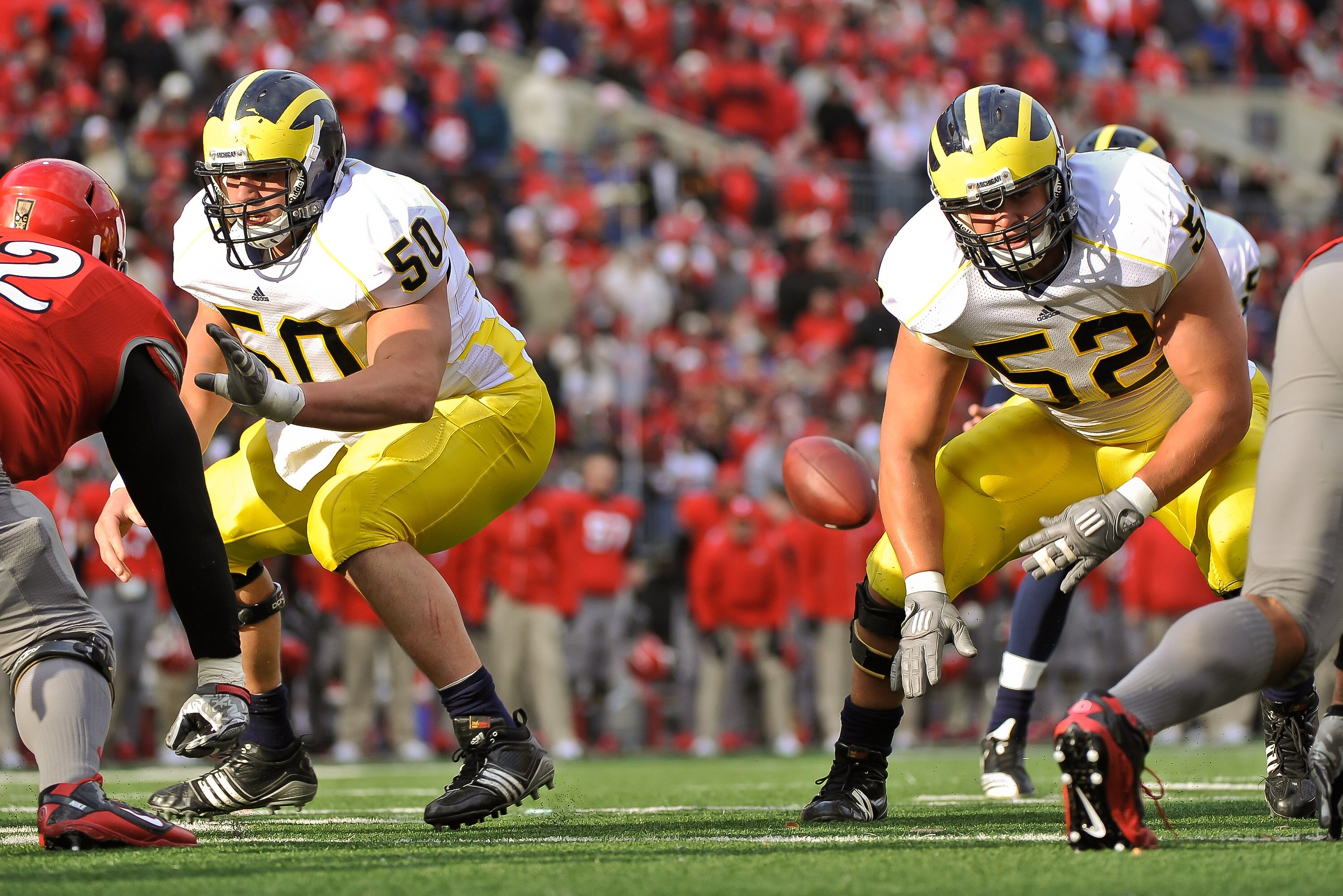 COLUMBUS, OH - NOVEMBER 27:  David Molk #50 of the Michigan Wolverines and Stephen Schilling #52 of the Michigan Wolverines block against the Ohio State Buckeyes at Ohio Stadium on November 27, 2010 in Columbus, Ohio.  (Photo by Jamie Sabau/Getty Images)