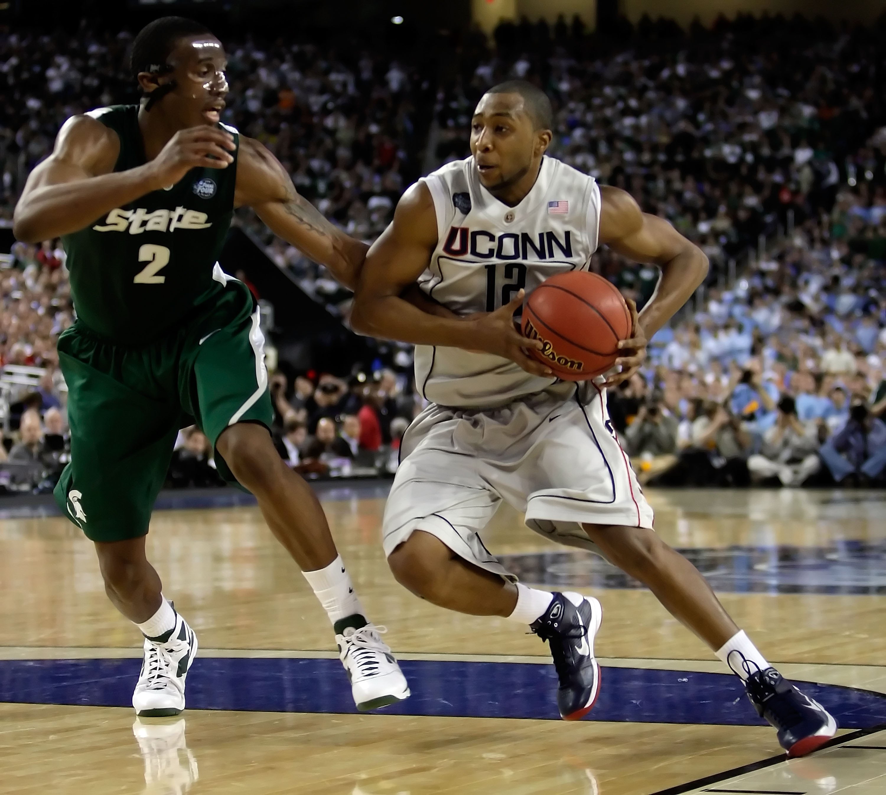 DETROIT - APRIL 04:  A.J. Price #12 of the Connecticut Huskies drives on Raymar Morgan #2 of the Michigan State Spartans during the National Semifinal game of the NCAA Division I Men's Basketball Championship at Ford Field on April 4, 2009 in Detroit, Mic