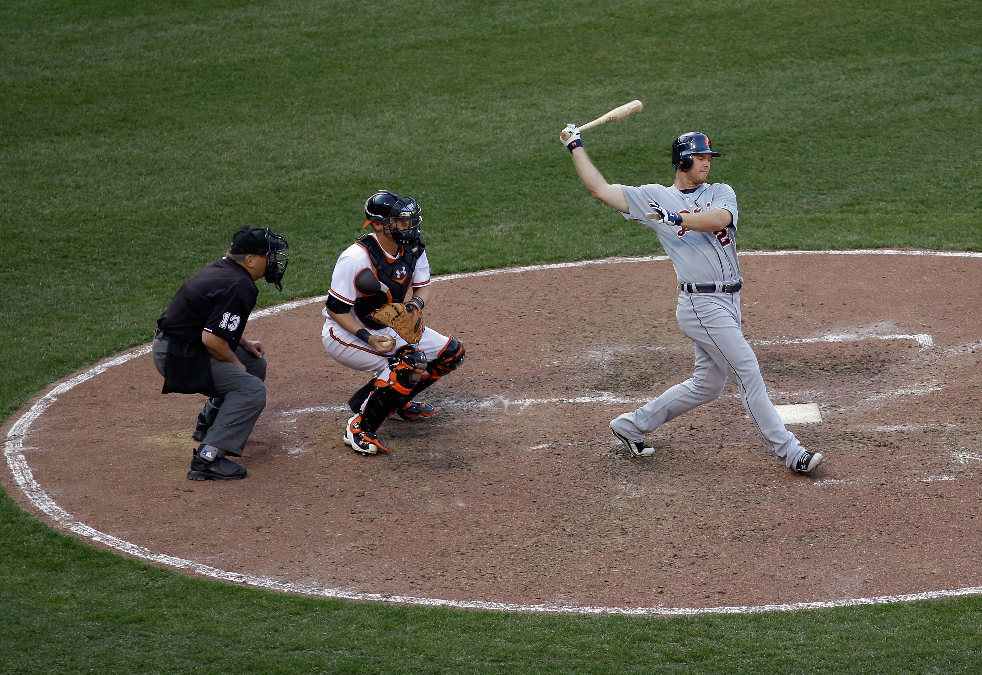 BALTIMORE, MD - APRIL 04:  Batter Brennan Boesch #26 of the Detroit Tigers strikes out swinging to end the eighth inning as umpire Derryl Cousins #13 and catcher Matt Wieters #32 of the Baltimore Orioles look on during opening day at Oriole Park at Camden