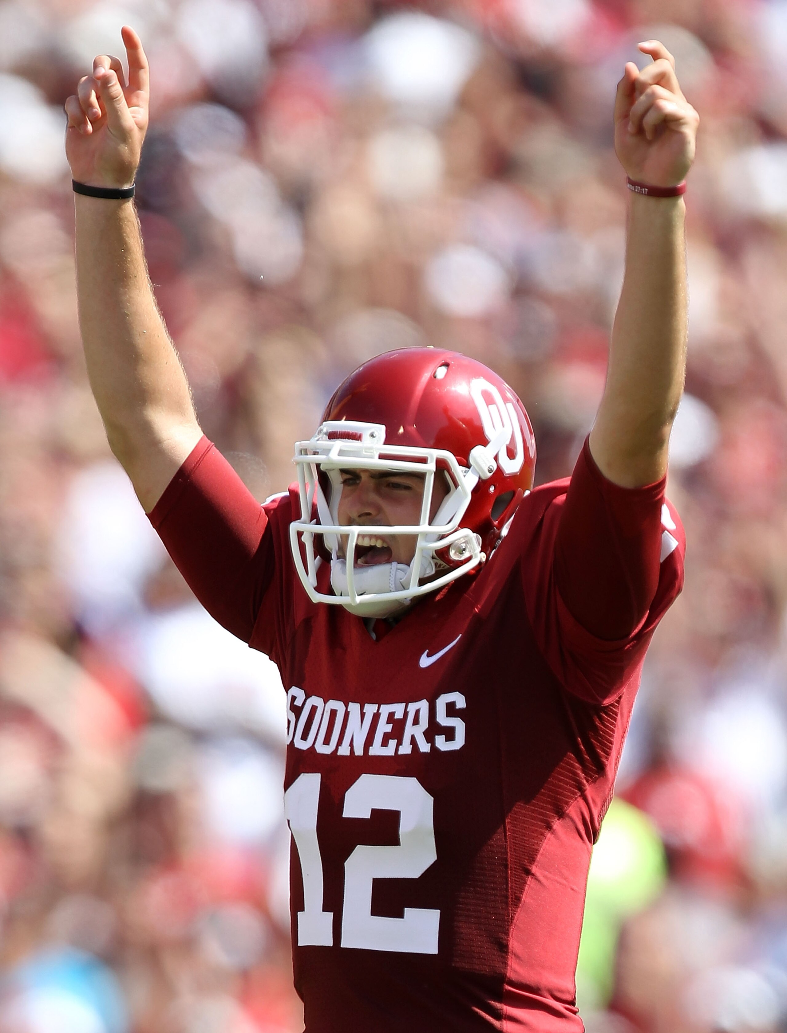 NORMAN, OK - SEPTEMBER 11:  Quarterback Landry Jones #12 of the Oklahoma Sooners celebrates a touchdown against the Florida State Seminoles in the first quarter at Gaylord Family Oklahoma Memorial Stadium on September 11, 2010 in Norman, Oklahoma.  (Photo