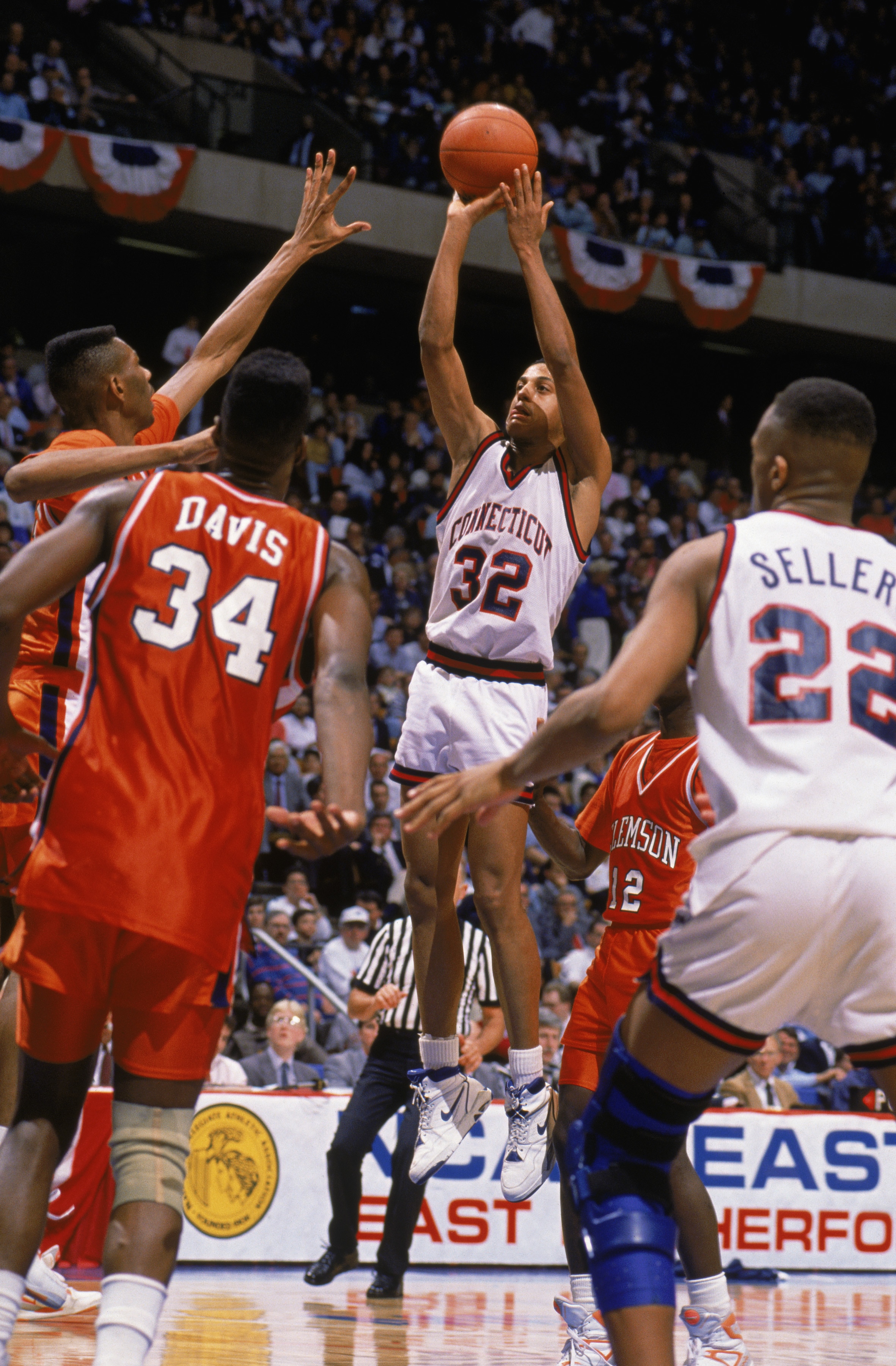 EAST RUTHERFORD, NJ - MARCH 22:  Tate George #32 of the UConn Huskies puts up a shot during the 1990 'sweet sixteen' NCAA Tournament basketball game against Clemson at the Meadowlands on March 22, 1990 in East Rutherford, New Jersey.  As time expires, Tat