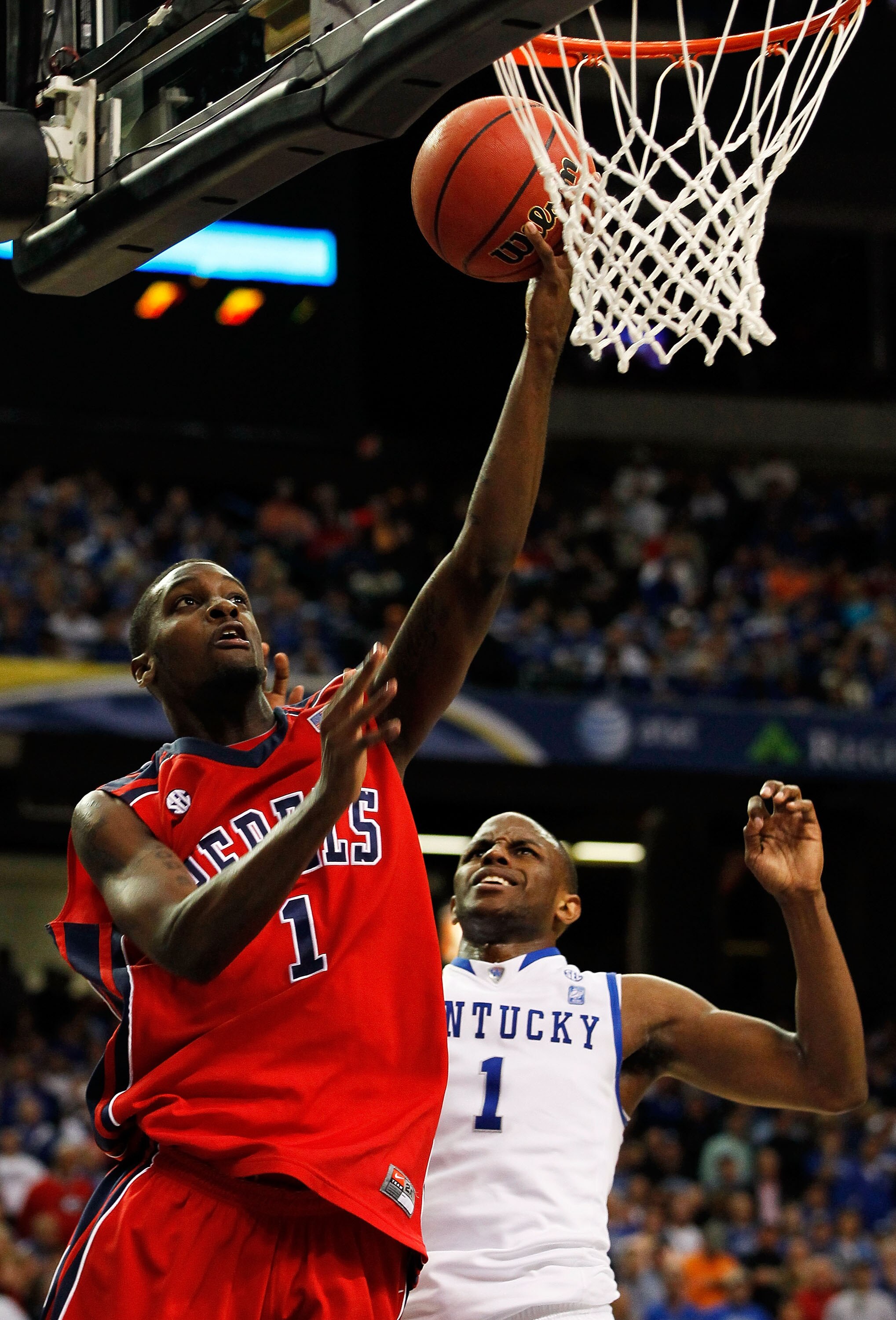 ATLANTA, GA - MARCH 11:  Terrance Henry #1 of the Ole Miss Rebels shoots against Darius Miller #1 of the Kentucky Wildcats during the quarterfinals of the SEC Men's Basketball Tournament at Georgia Dome on March 11, 2011 in Atlanta, Georgia. The Wildcats