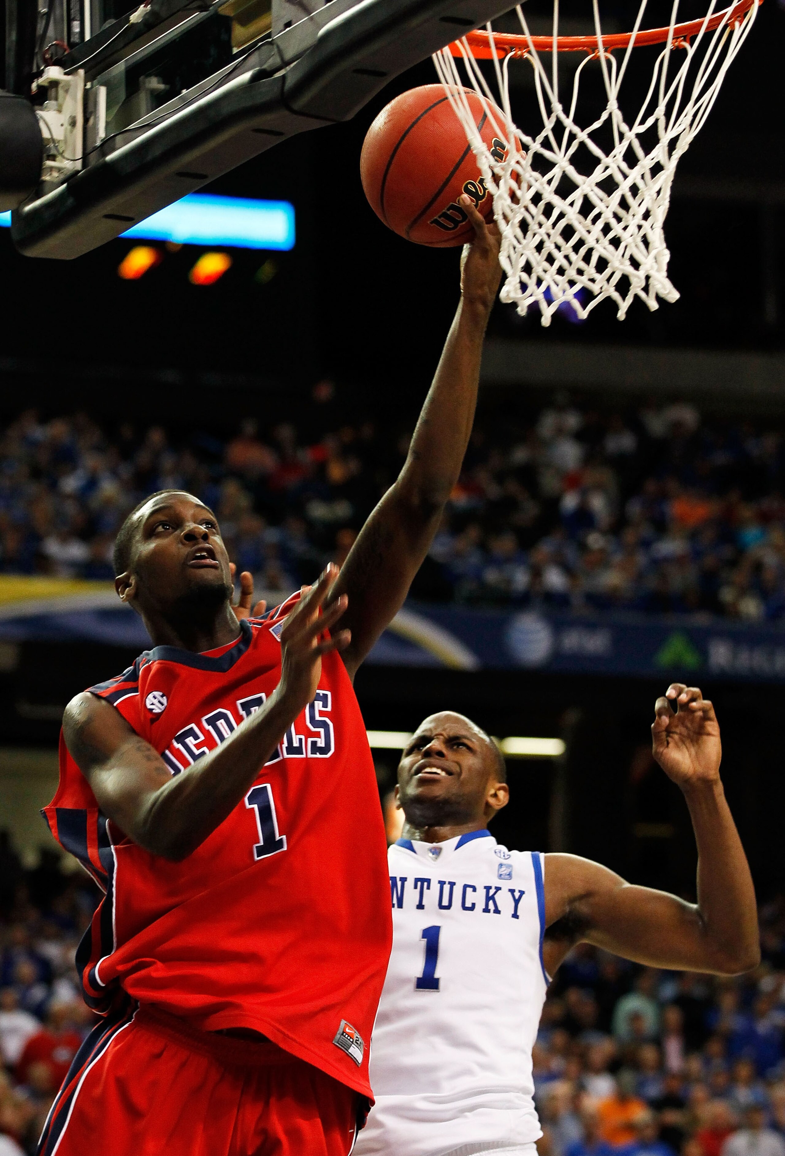 ATLANTA, GA - MARCH 11:  Terrance Henry #1 of the Ole Miss Rebels shoots against Darius Miller #1 of the Kentucky Wildcats during the quarterfinals of the SEC Men's Basketball Tournament at Georgia Dome on March 11, 2011 in Atlanta, Georgia. The Wildcats