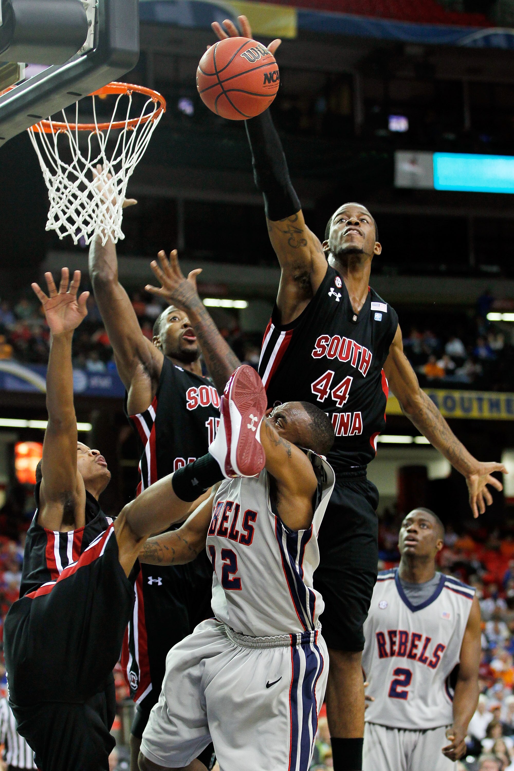 ATLANTA, GA - MARCH 10:  Sam Muldrow #44 of the South Carolina Gamecocks blocks a shot by Chris Warren #12 of the Ole Miss Rebels during the first round of the SEC Men's Basketball Tournament at the Georgia Dome on March 10, 2011 in Atlanta, Georgia.  (Ph