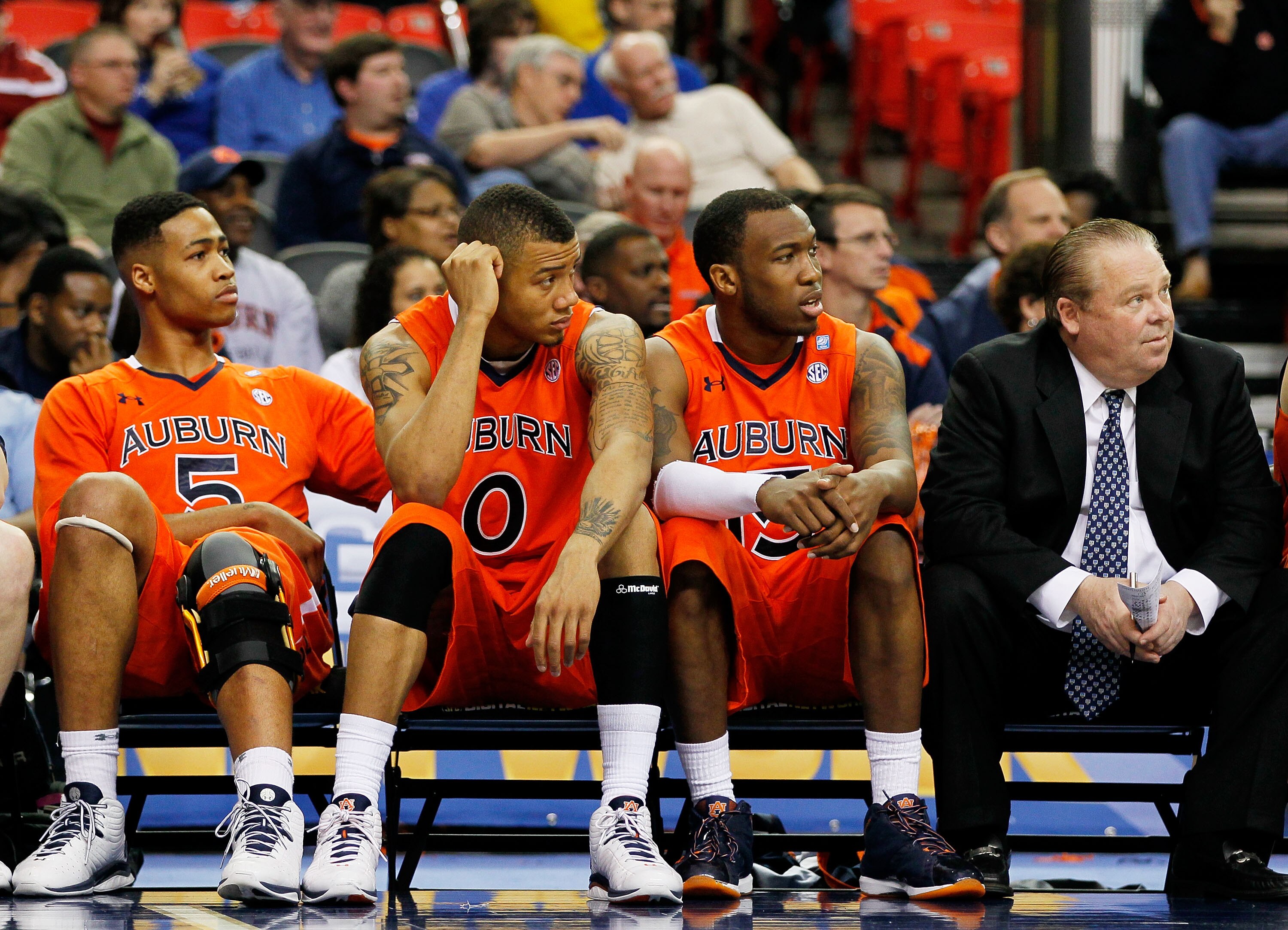 ATLANTA, GA - MARCH 10:  Ty Armstrong #5, Josh Langford #0, Tony Neysmith #15 and Exectutive director of basketball for athe Auburn Tigers Steve Smith react during their 51 to 69 loss to the Georgia Bulldogs during the first round of the SEC Men's Basketb