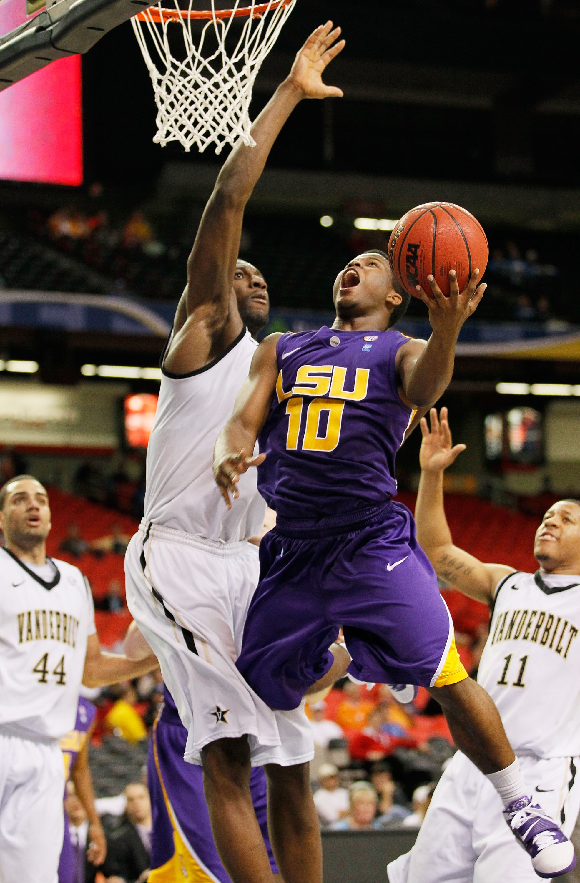 ATLANTA, GA - MARCH 10:  Andre Stringer #10 of the LSU Tigers shoots against Festus Ezeli #3 of the Vanderbilt Commodores during the first round of the SEC Men's Basketball Tournament at the Georgia Dome on March 10, 2011 in Atlanta, Georgia. The Commodor