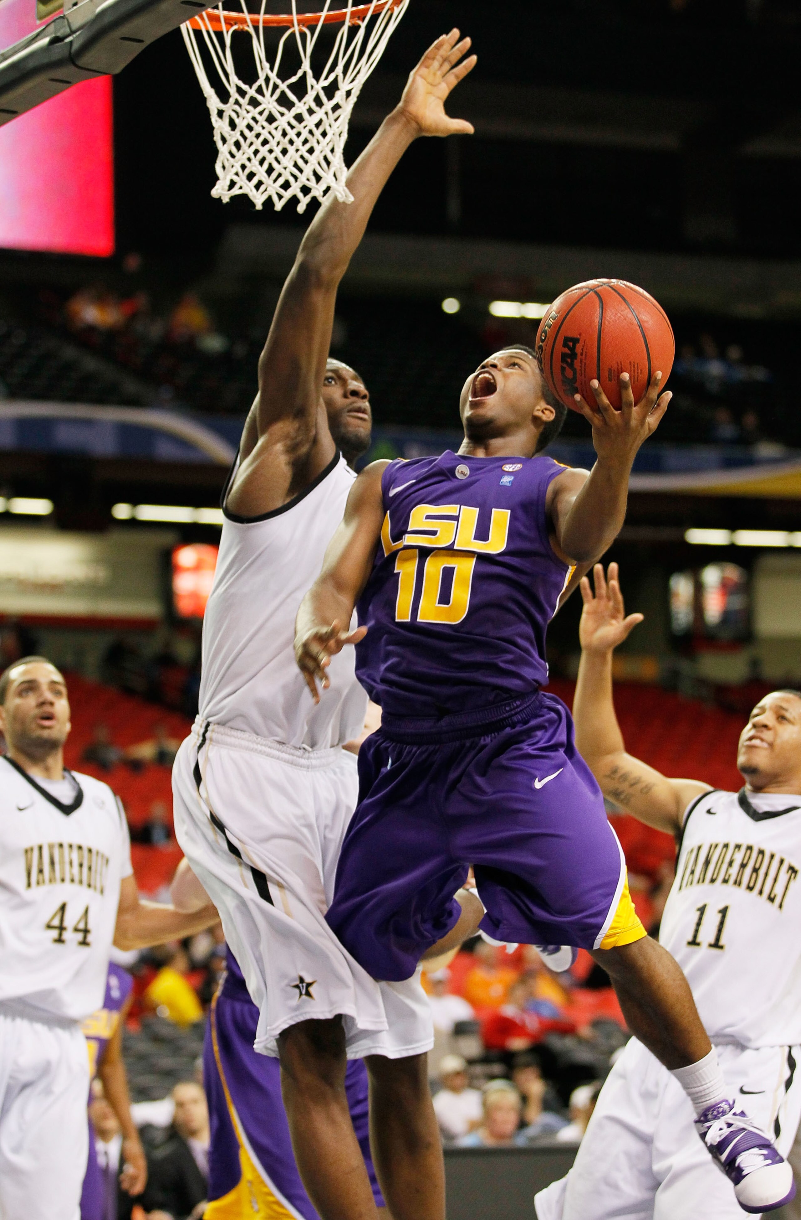 ATLANTA, GA - MARCH 10:  Andre Stringer #10 of the LSU Tigers shoots against Festus Ezeli #3 of the Vanderbilt Commodores during the first round of the SEC Men's Basketball Tournament at the Georgia Dome on March 10, 2011 in Atlanta, Georgia. The Commodor