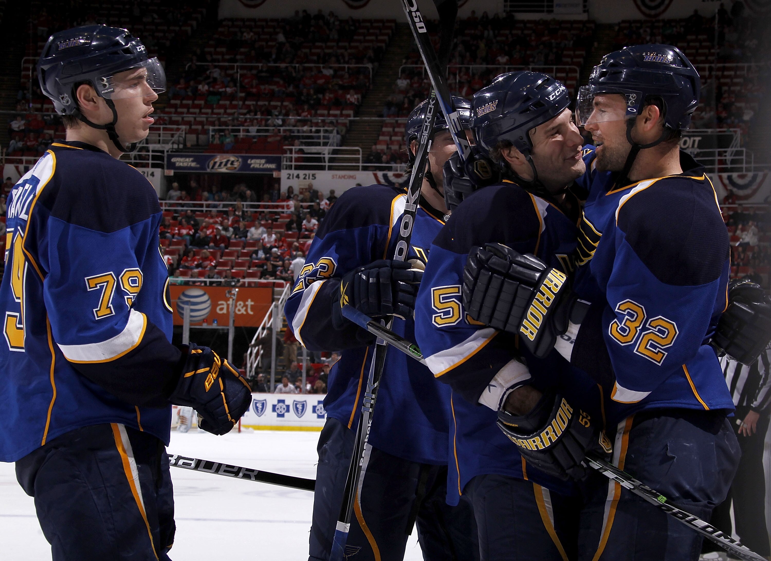 DETROIT, MI - MARCH 30:  Chris Porter #32 of the St. Louis Blues celebrates a third-period goal with teammates Cam Janssen #55 and Adam Cracknell #79 while playing the Detroit Red Wings at Joe Louis Arena on March 30, 2011 in Detroit, Michigan. St. Louis